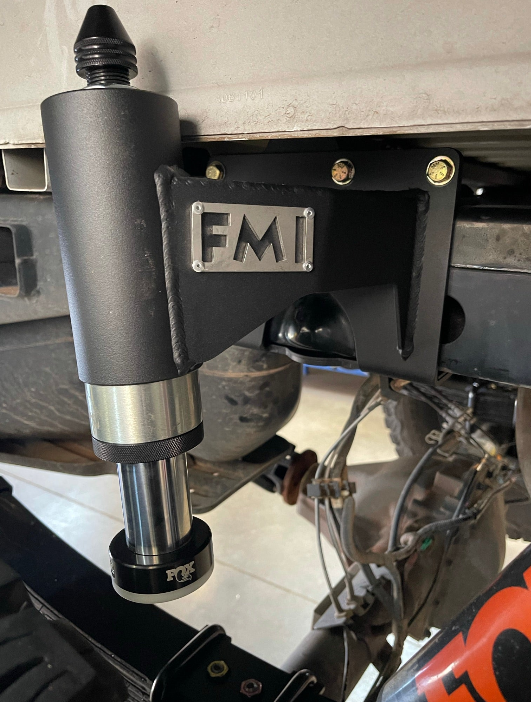 2010-2014 Ford Raptor Bump Stop Kit by Foutz Motorsports mounted on a truck frame, showcasing durable construction and design.