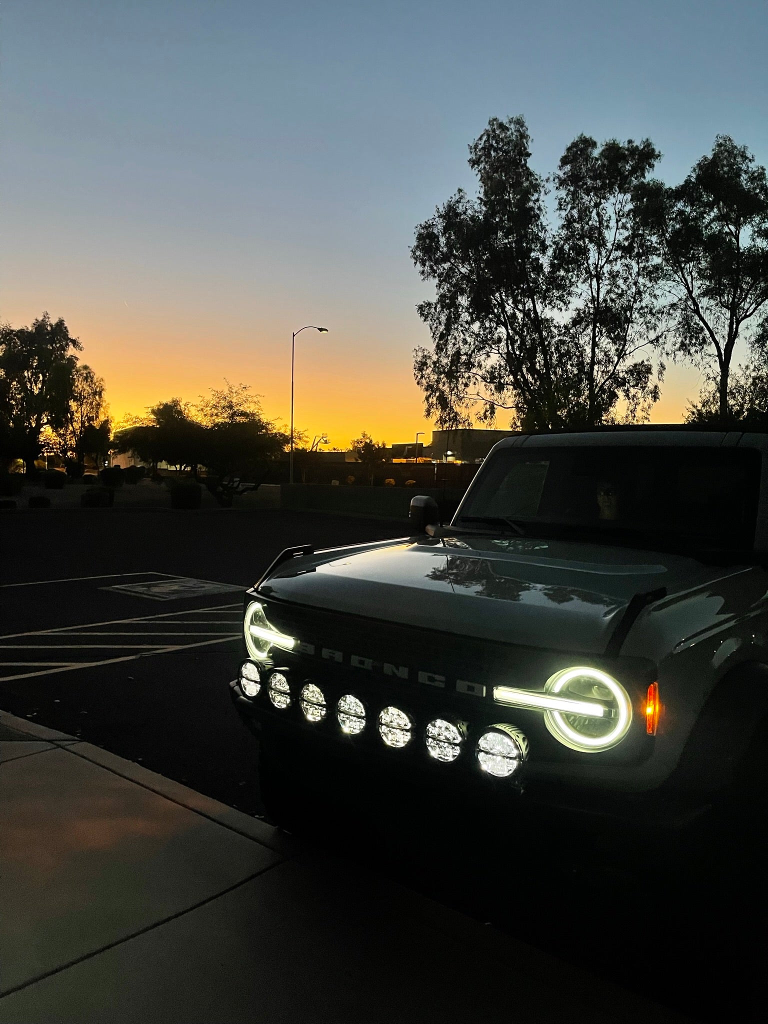 2022-UP Bronco Raptor front light mount kit showcasing versatile light options against a sunset backdrop.