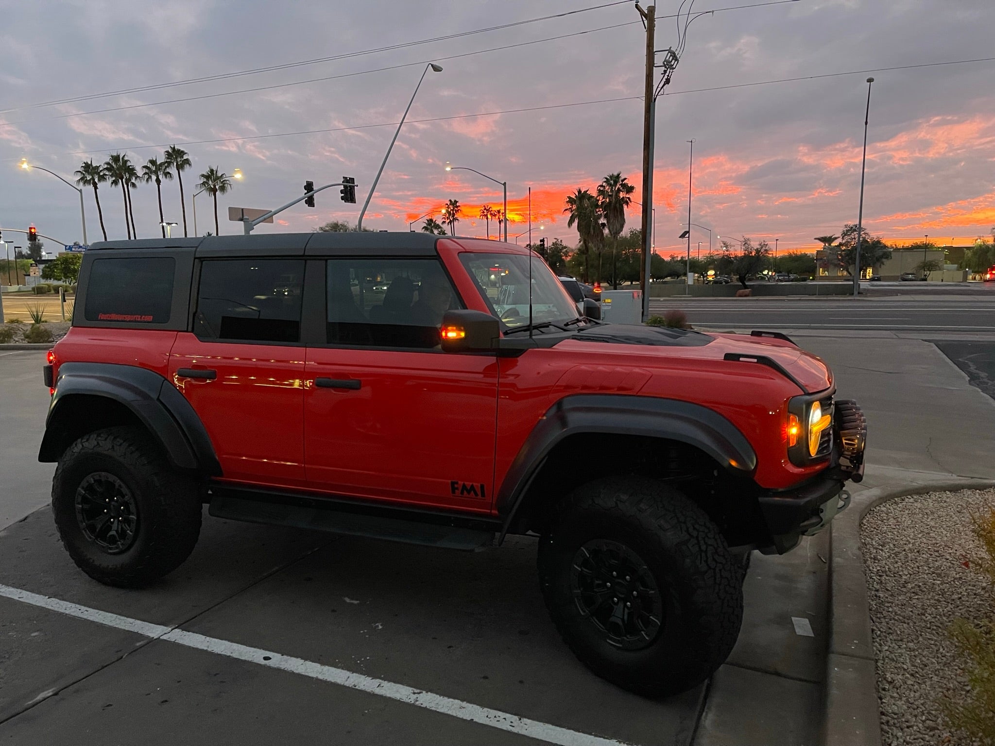 2022-UP Bronco Raptor front leveling kit installed on a red Bronco, showcasing enhanced stance and off-road readiness.