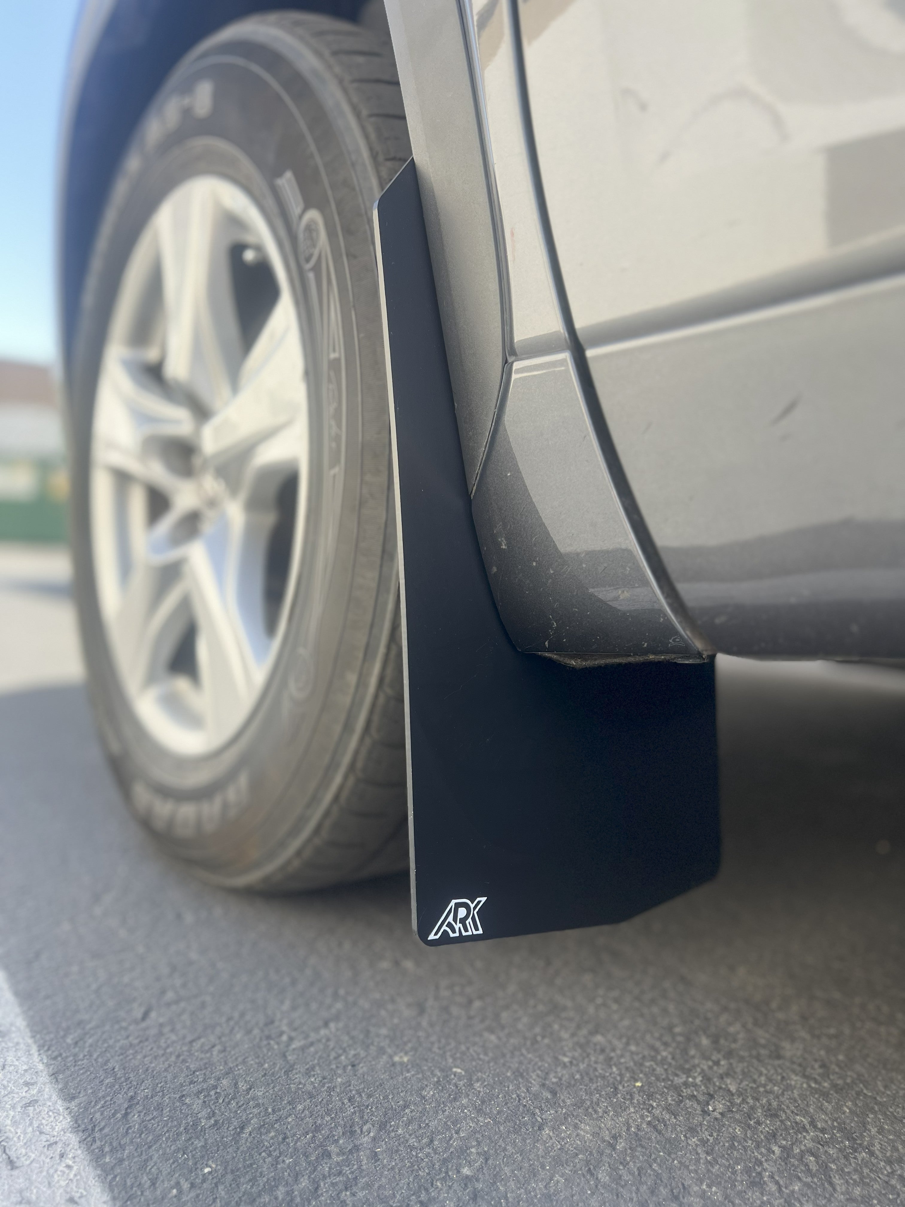 2020+ Toyota Highlander TriXPoly Mudflaps installed on a vehicle, providing protection against mud and debris.