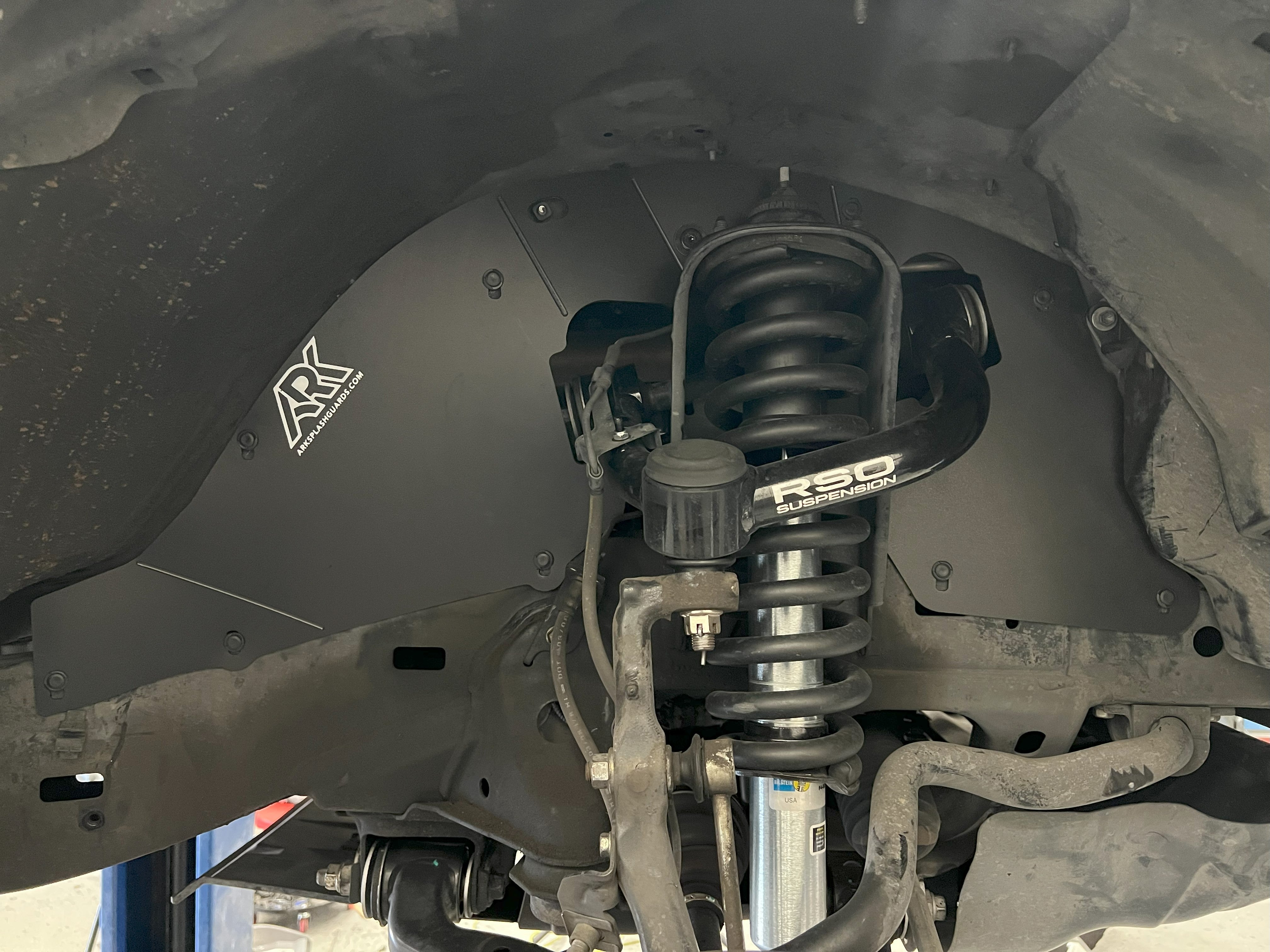 TriXPoly splash guards installed on a 2003-2009 Toyota 4Runner, providing protection for undercarriage components.