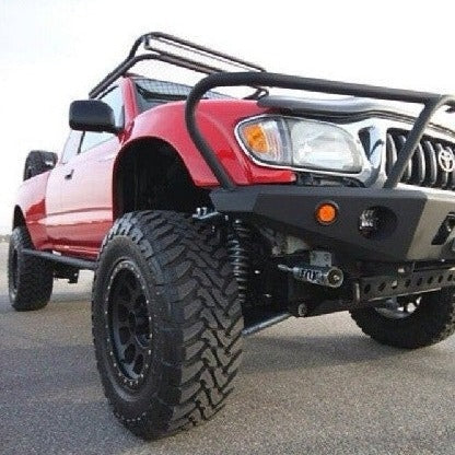1995-2004 Toyota Tacoma fenders showcasing a lifted truck with off-road tires and a rugged front bumper.