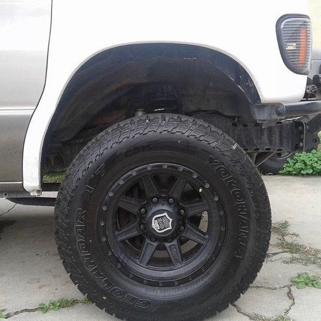 1992-2007 Ford Econoline Van fender with a black wheel and tire, showcasing offroad capability and style.