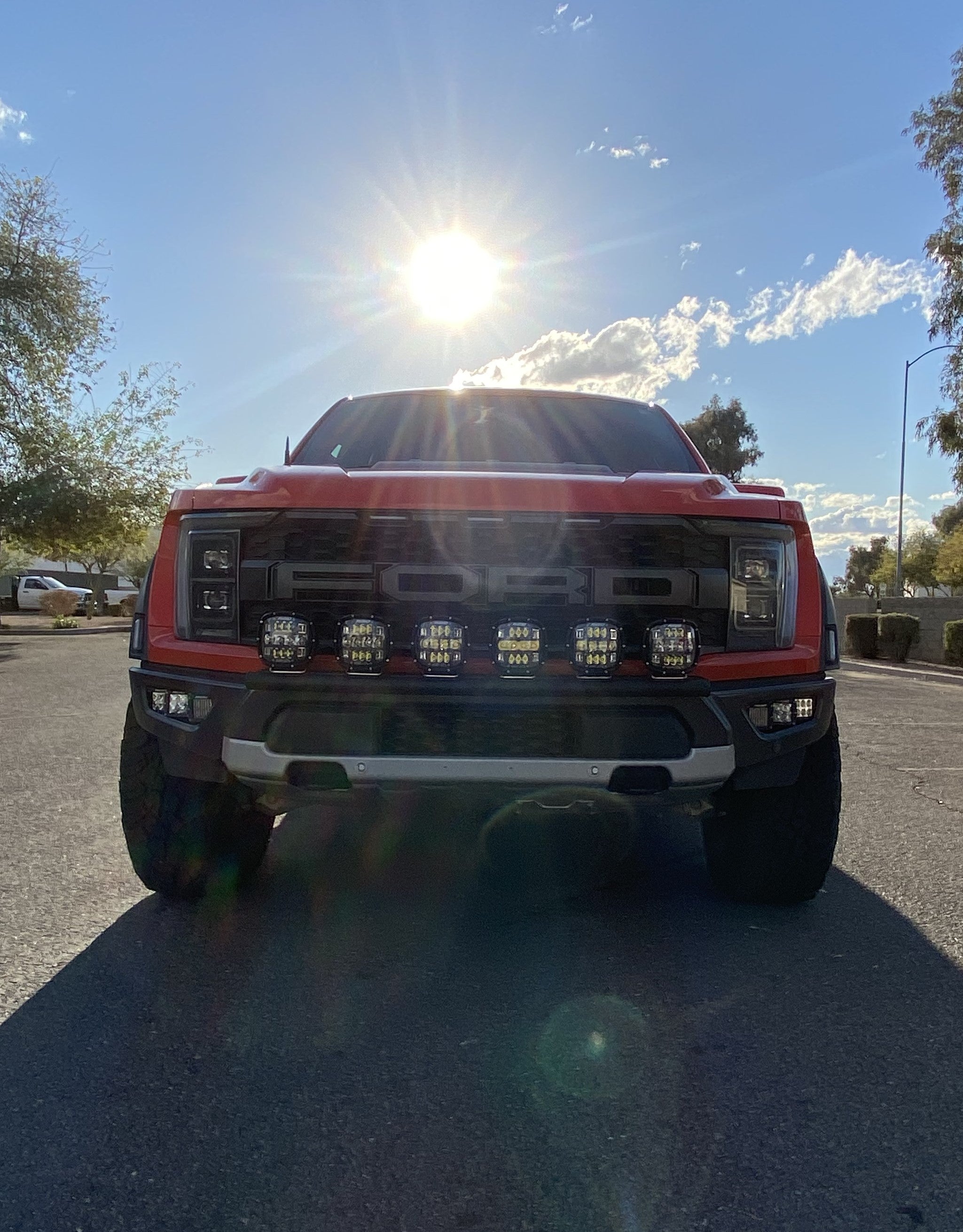 2024 Raptor Front Light Mount Kit for modular bumpers, showcasing customizable light options on a red truck.