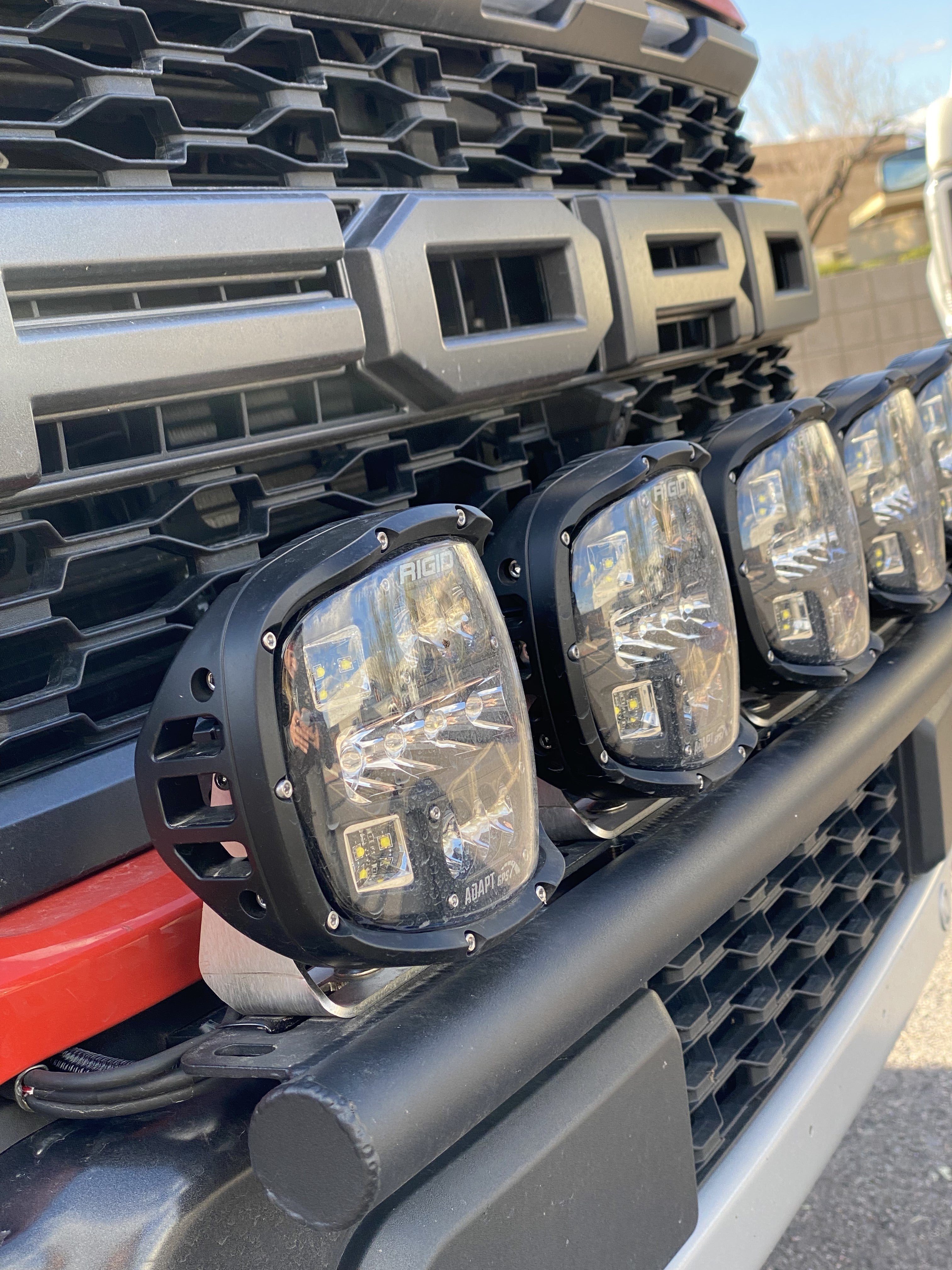 2024 Raptor Front Light Mount Kit with multiple lights installed on a modular bumper for enhanced visibility and customization.