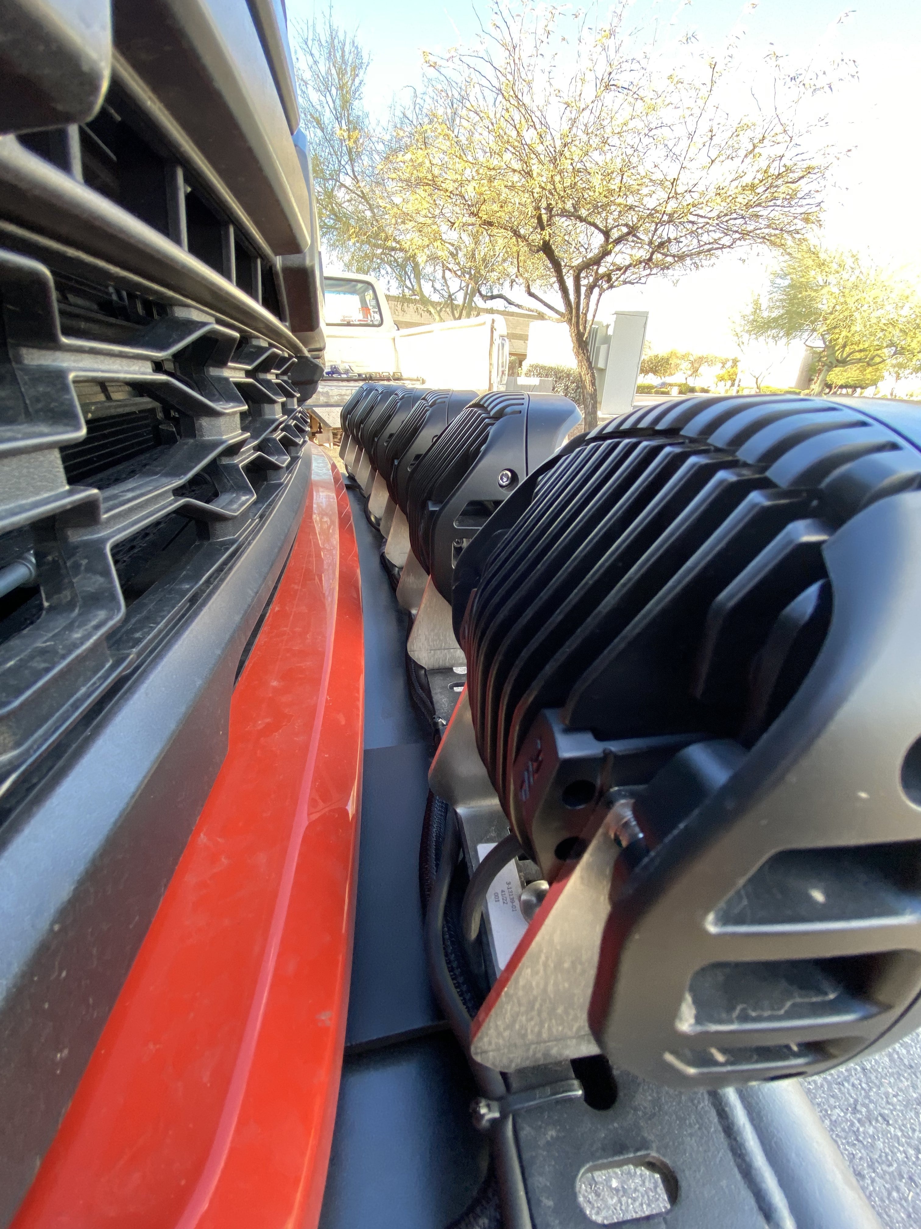 2024 Raptor Front Light Mount Kit installed on a modular bumper, showcasing multiple lights for enhanced visibility.