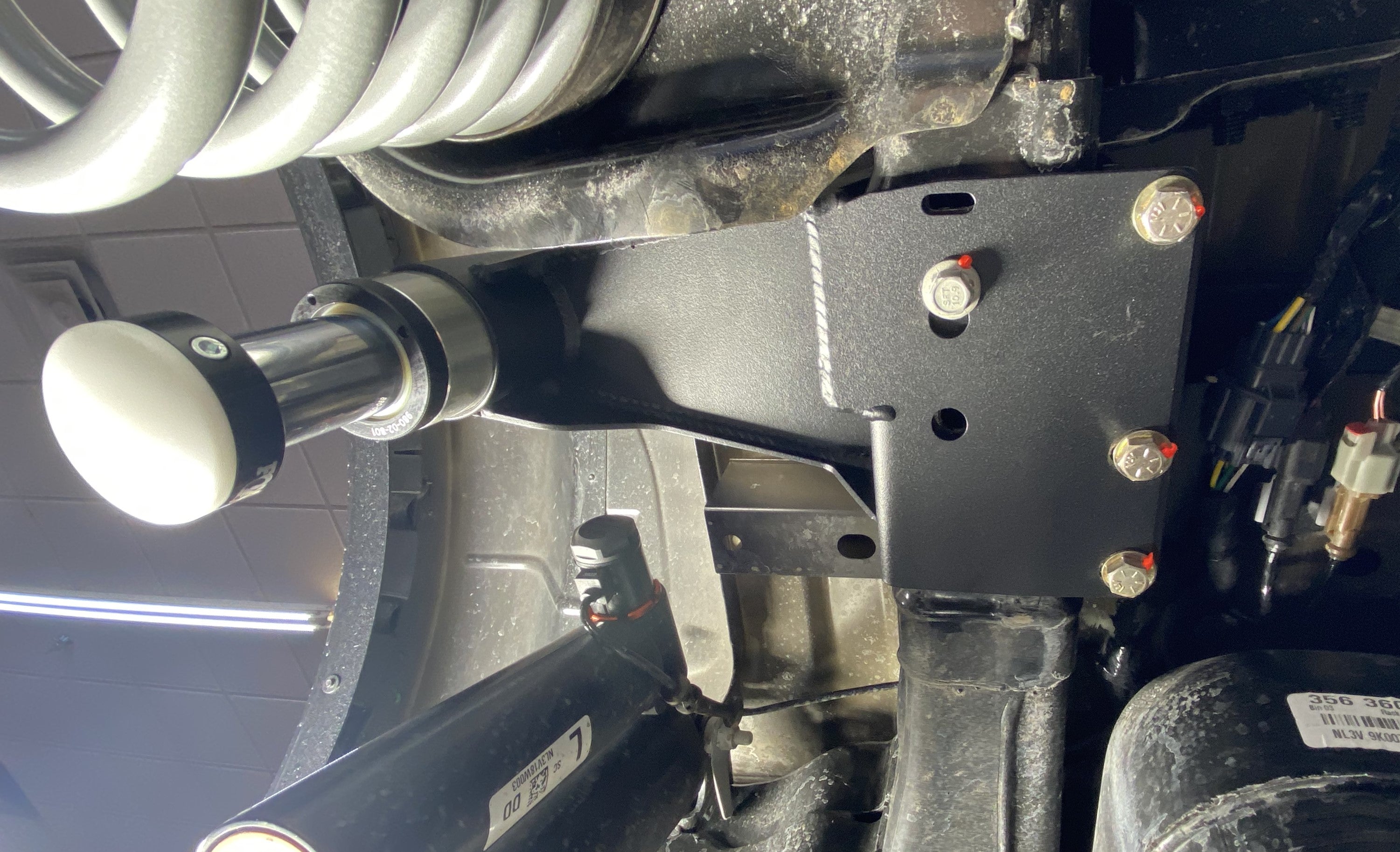 2021-2024 Ford Raptor rear bump stop kit installed, showcasing the mounting bracket and shock absorber components.