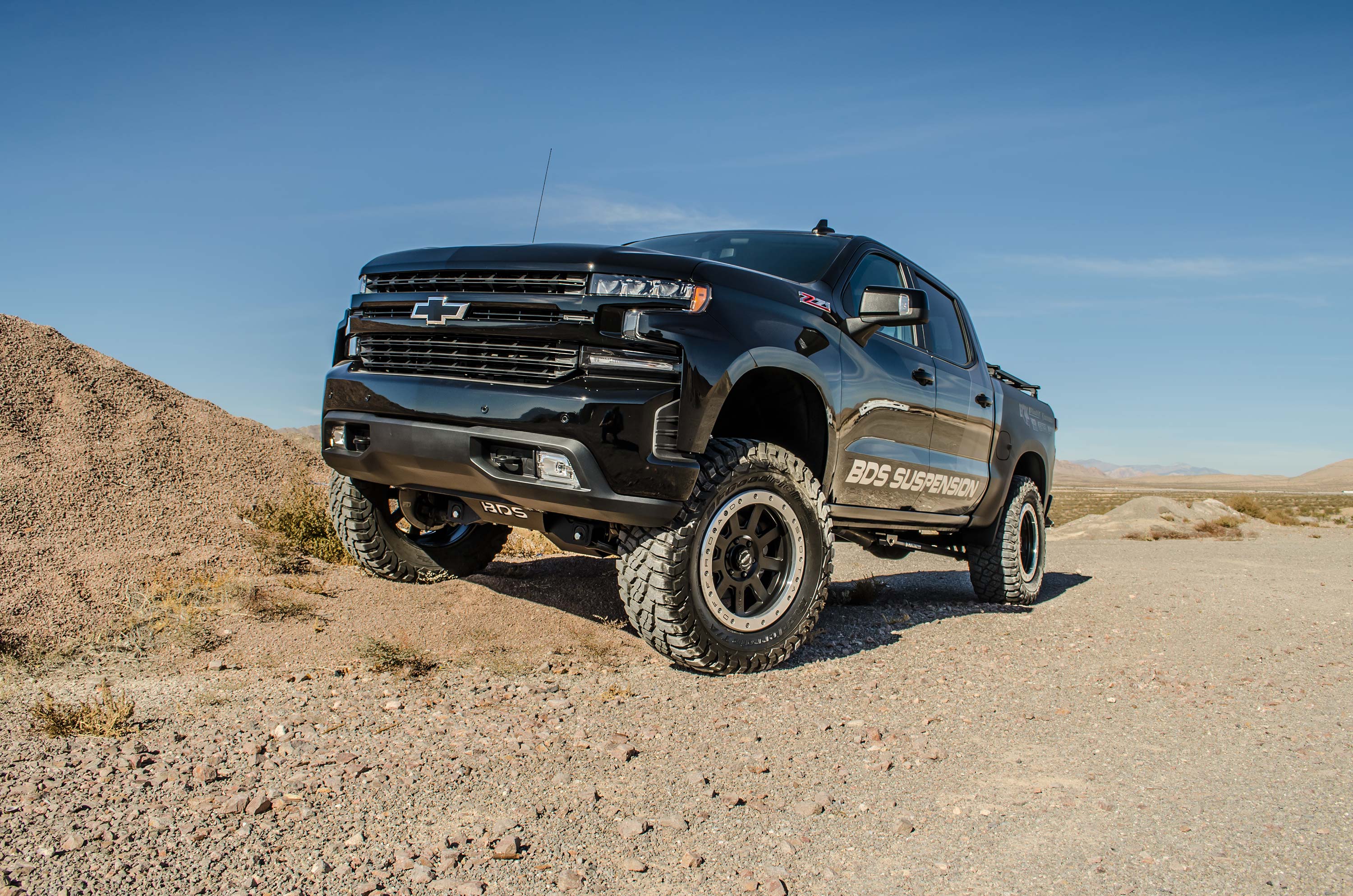 4-inch lift kit with FOX 2.5 coil-over on a lifted Chevy Trail Boss in a desert setting, showcasing offroad capabilities.