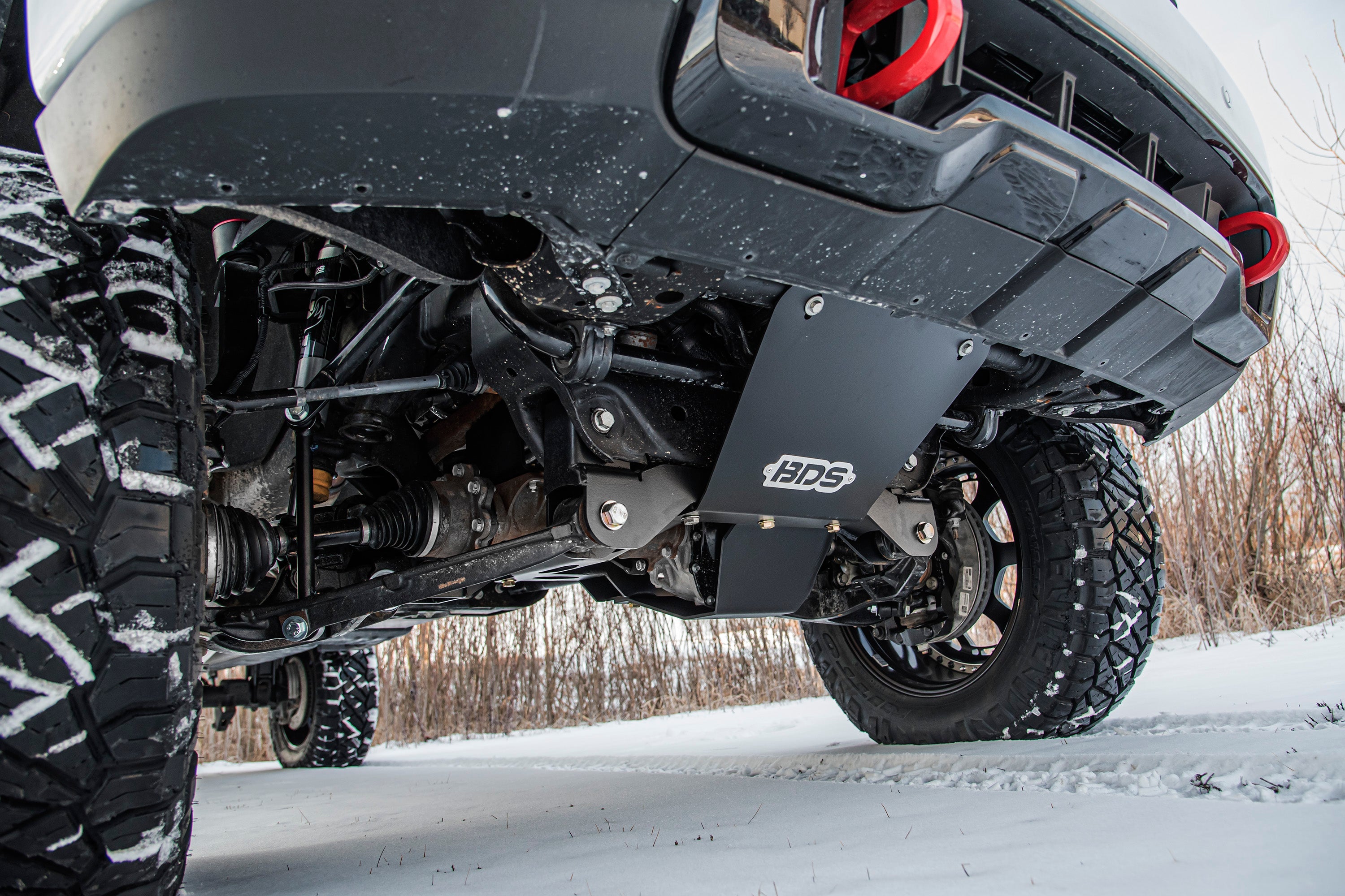 6.5 inch lift kit installed on a Chevy Silverado or GMC Sierra 2500HD/3500HD, showcasing undercarriage components and rugged tires.