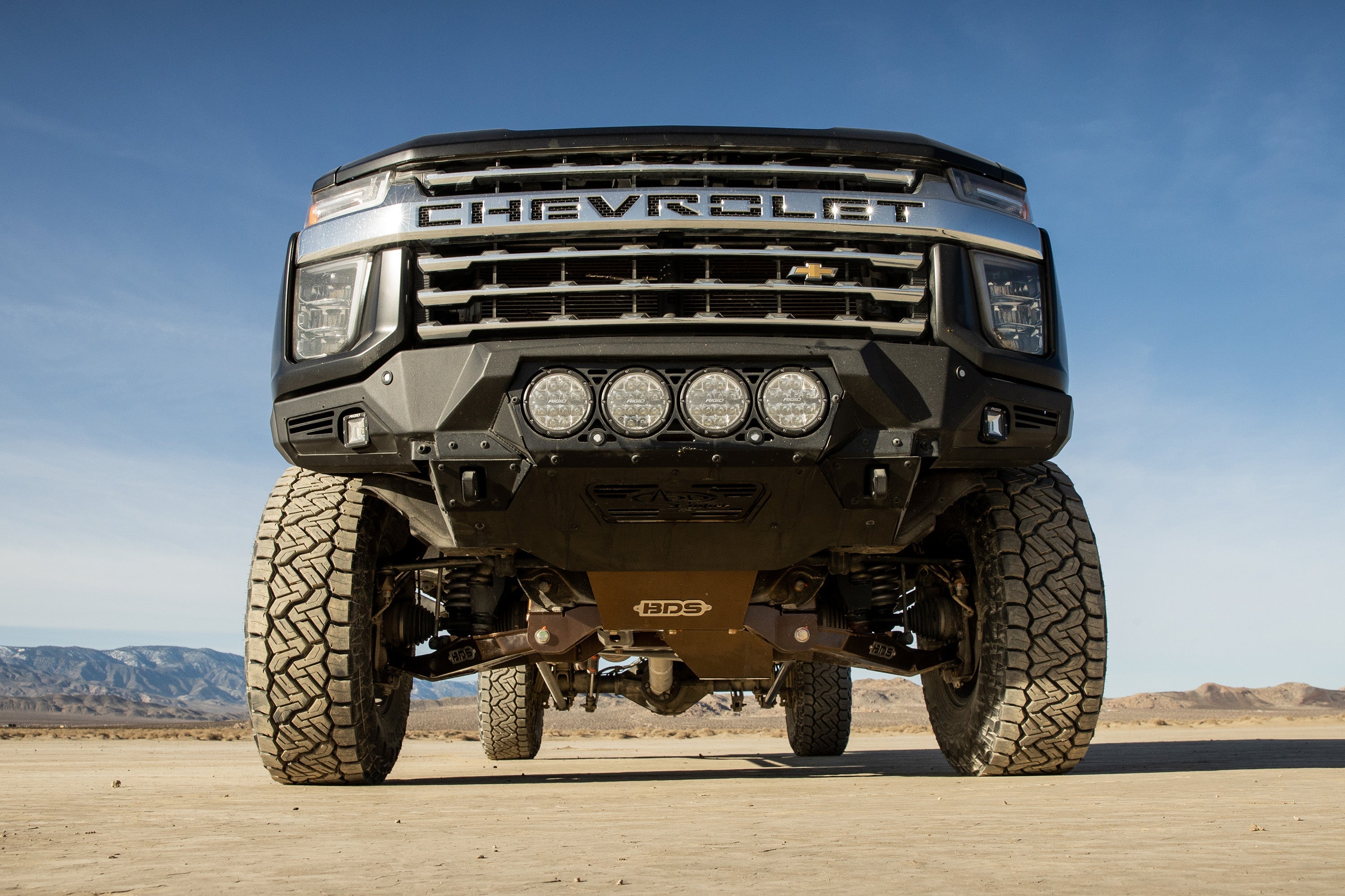 6.5 inch lift kit for Chevy Silverado or GMC Sierra 2500HD/3500HD with FOX 2.5 coil-over conversion showcased in desert setting.