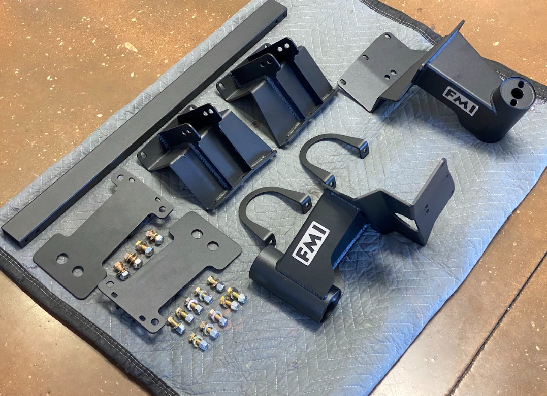 2010-2014 Ford Raptor Bump Stop Kit by Foutz Motorsports featuring metal components and hardware for installation.