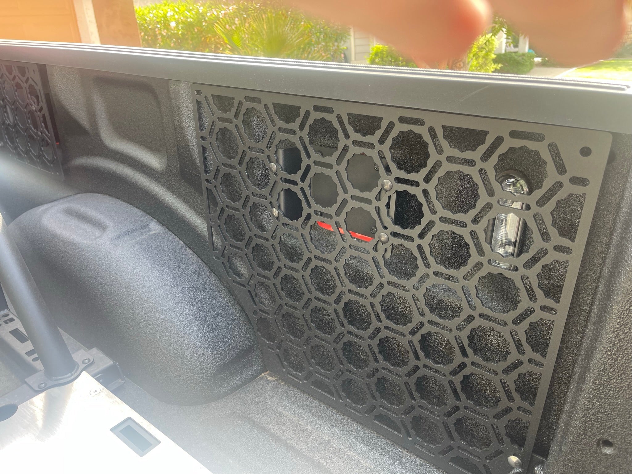 Bedside organizer panel kit for 2021-2023 Ford Raptor and F150, featuring a honeycomb design for efficient storage.