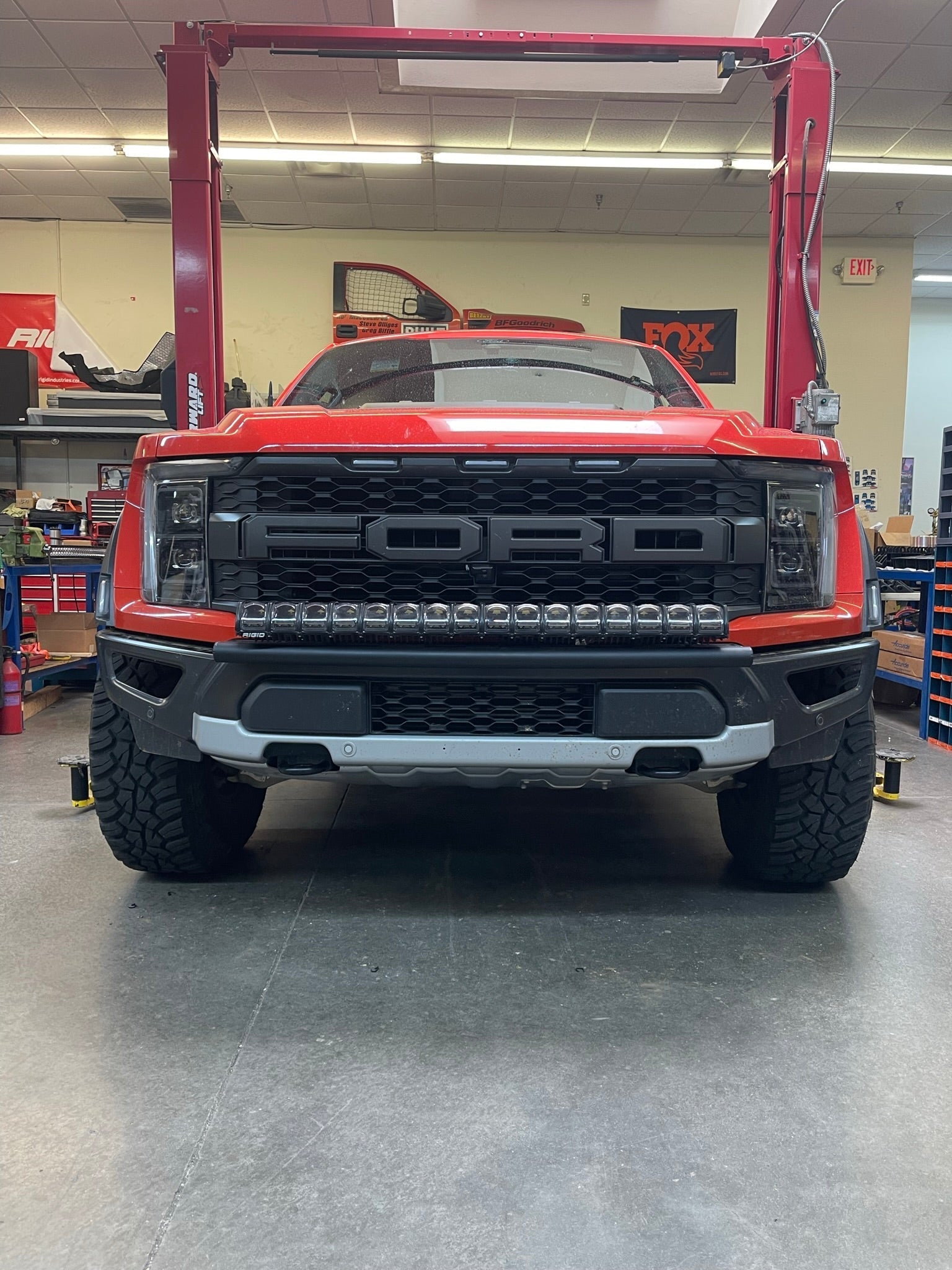 2024 Raptor Front Light Mount Kit displayed on a red truck with a modular bumper, showcasing versatile light installation options.