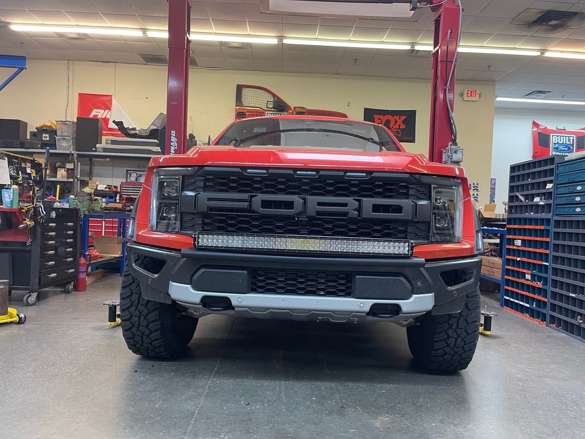 2024 Raptor front light mount kit displayed on a red truck, showcasing a modular bumper for versatile light installation.