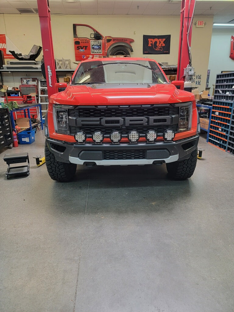 2024 Raptor Front Light Mount Kit displayed on a red truck, showcasing modular bumper and multiple light options.