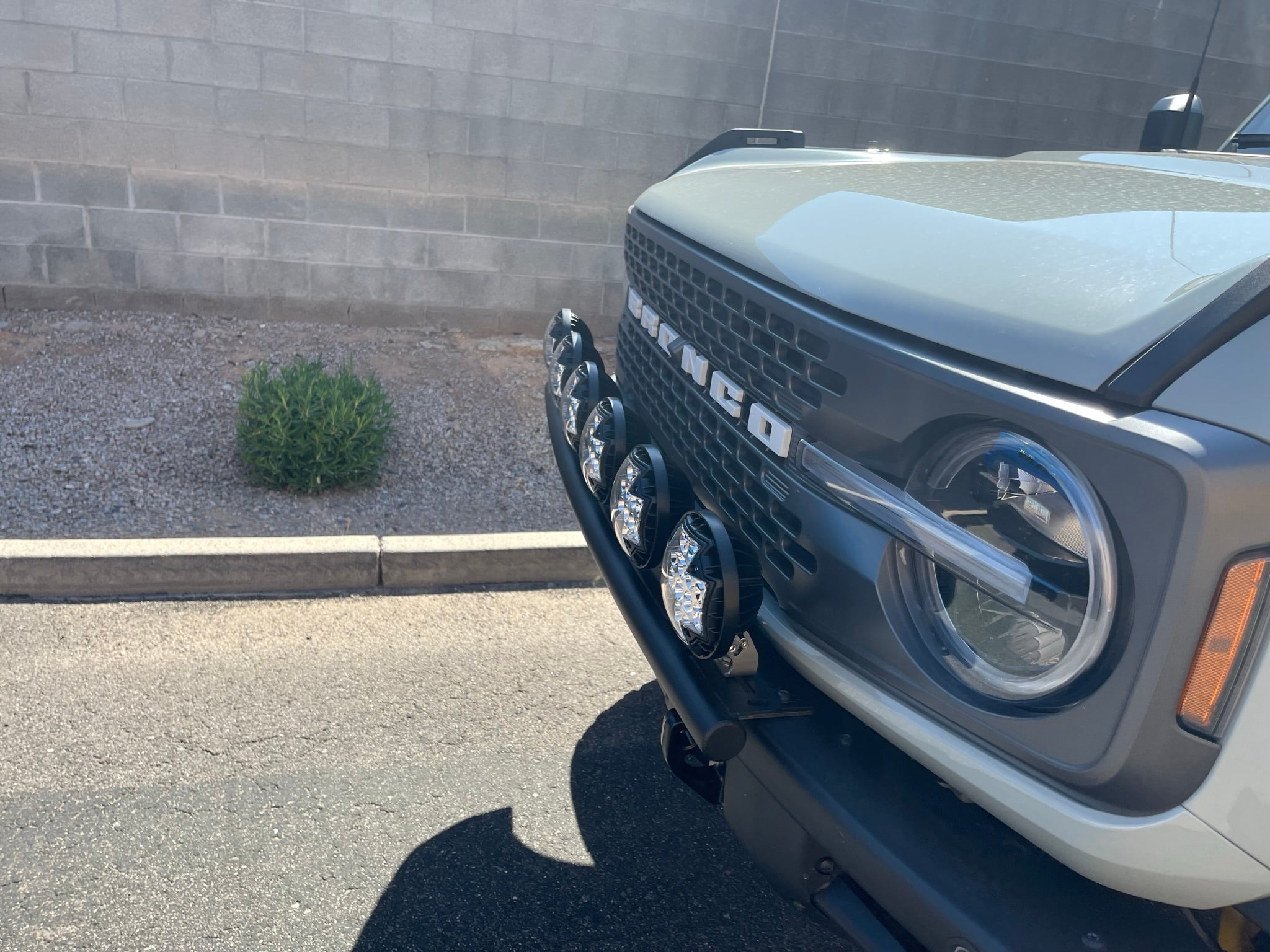Front view of a 6th Gen Bronco with a light mount kit installed on the modular stock bumper, showcasing multiple lights.