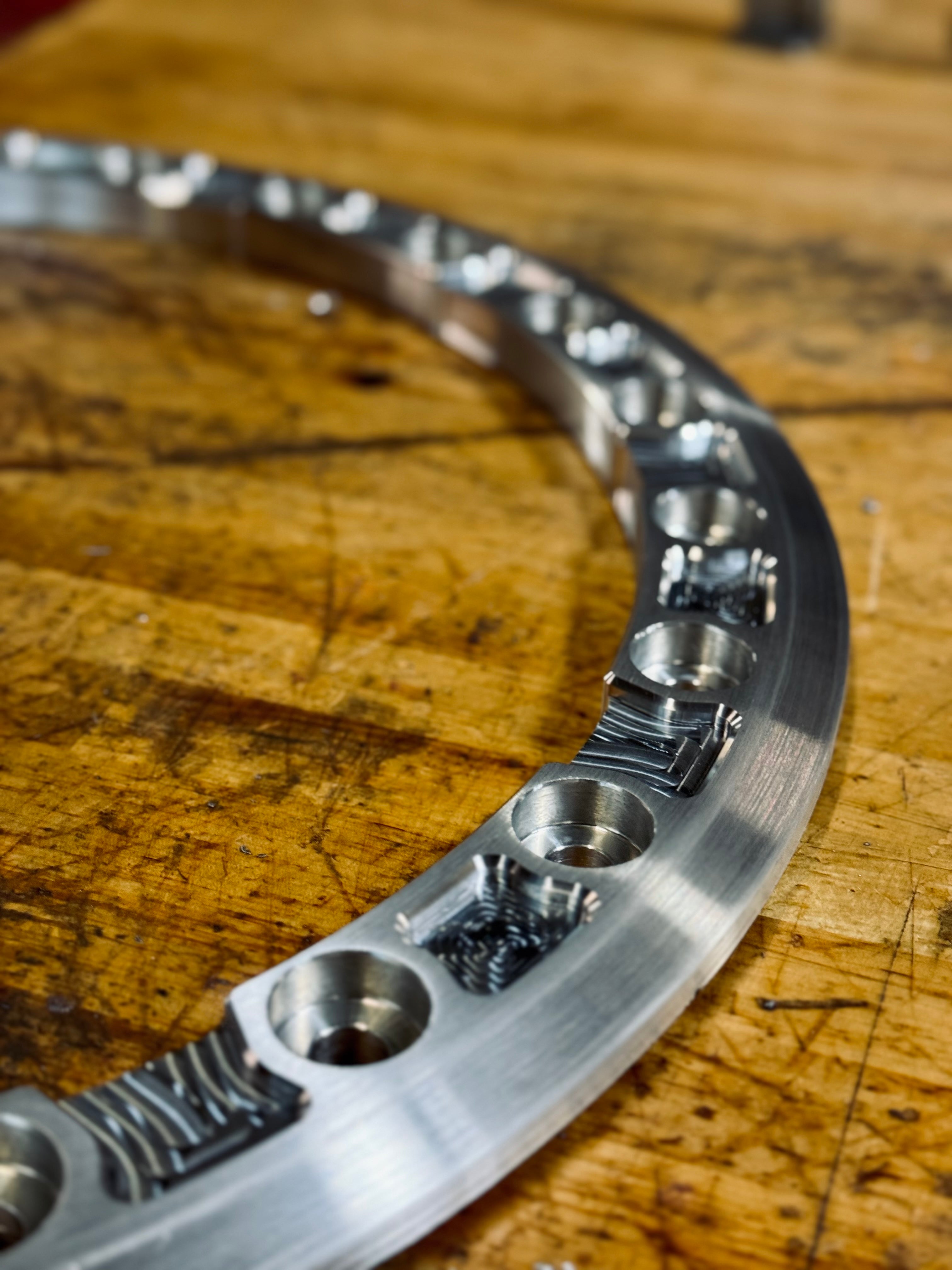Aluminum beadlock ring showcasing precision machining and multiple mounting points for enhanced tire security.