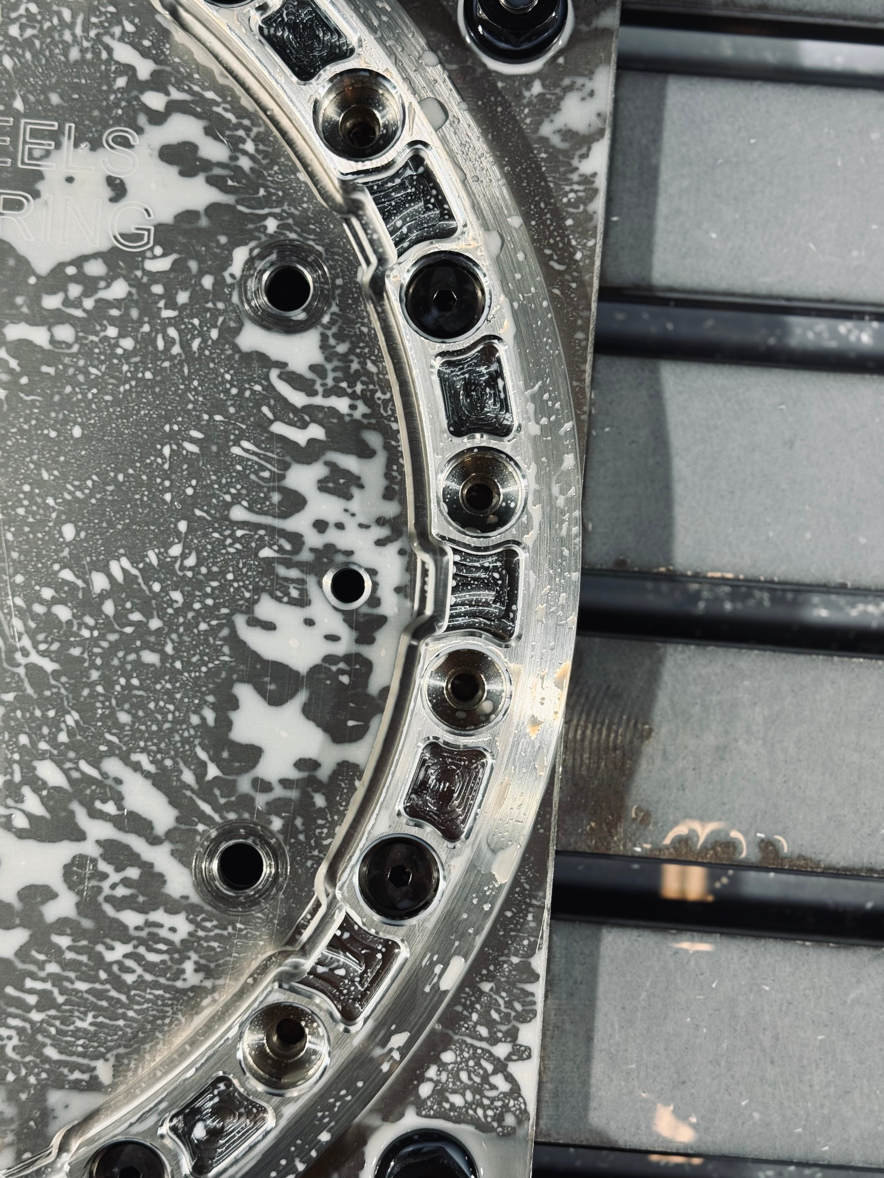 Close-up of an aluminum beadlock ring showcasing its polished surface and bolt holes, ideal for offroad wheel customization.