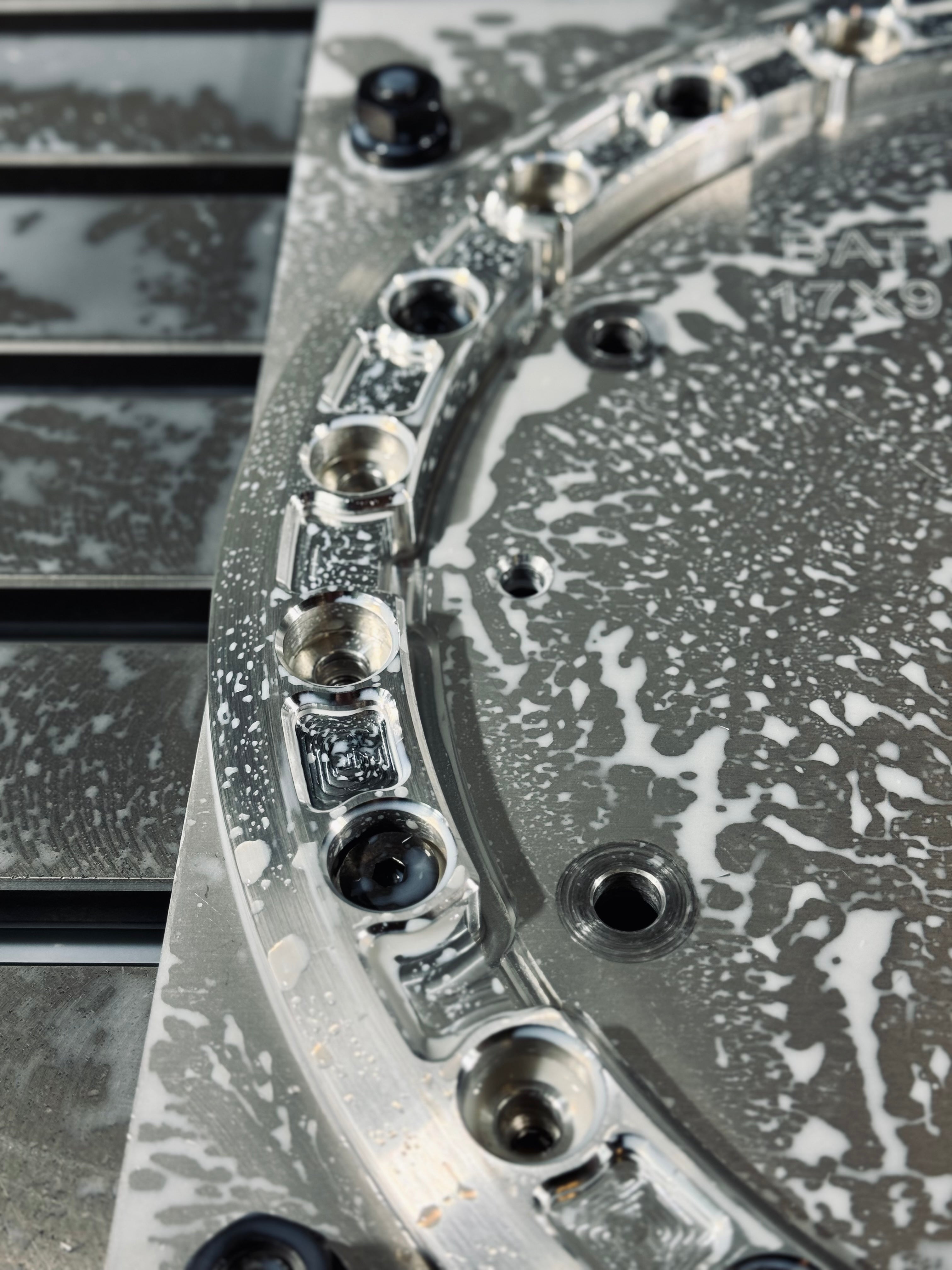 Close-up of an aluminum beadlock ring showing detailed machining and cleaning residue, ideal for offroad vehicle customization.