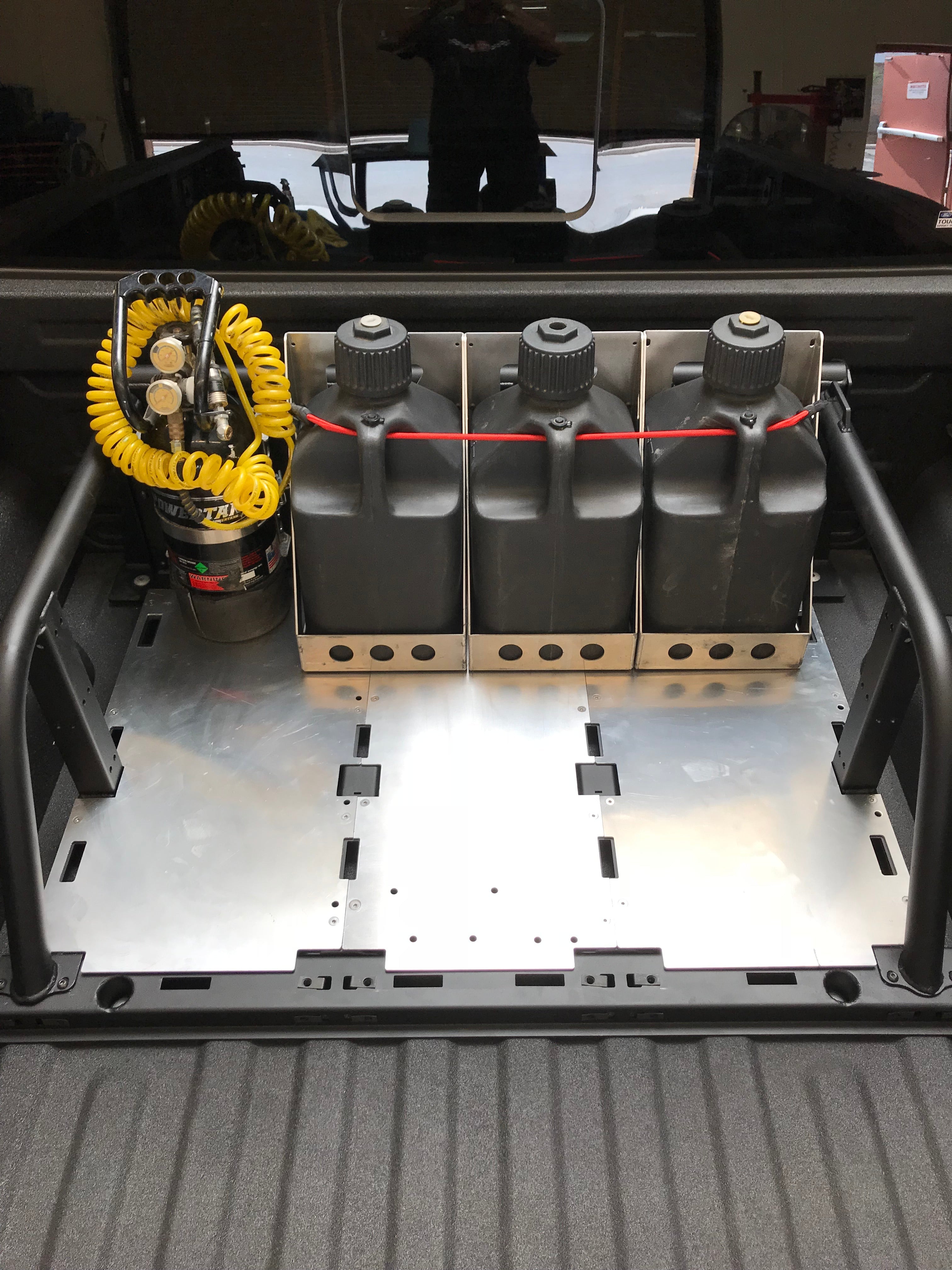 Modular bed organizer for 2017-2024 Ford Raptor and F150, featuring storage for containers and tools in a truck bed.