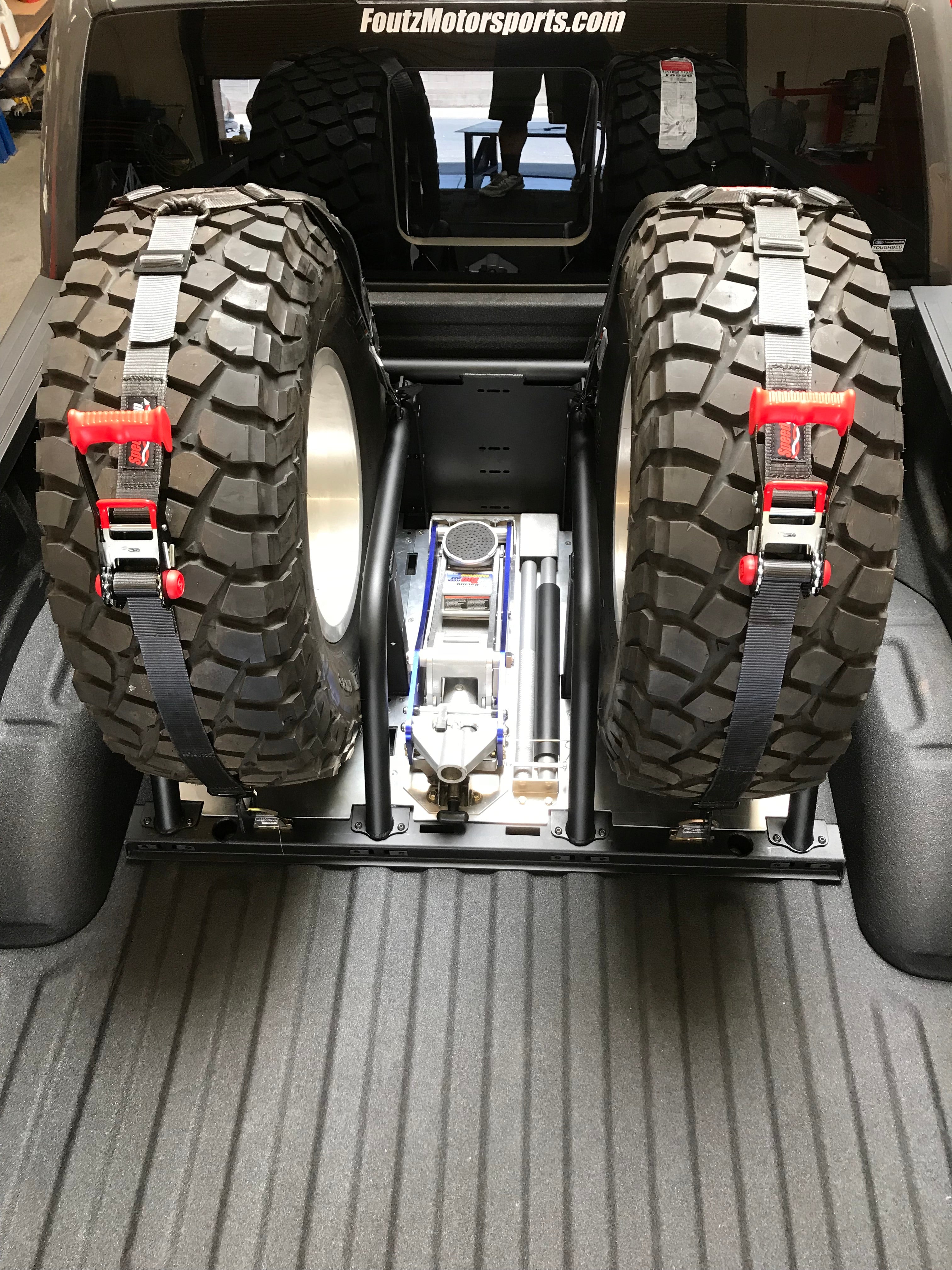 2021+ Raptor 5-Link Rear Bed Organizer with two mounted tires and tools, designed for 3.0x16 coil over or 3.5x16 bypass shocks.