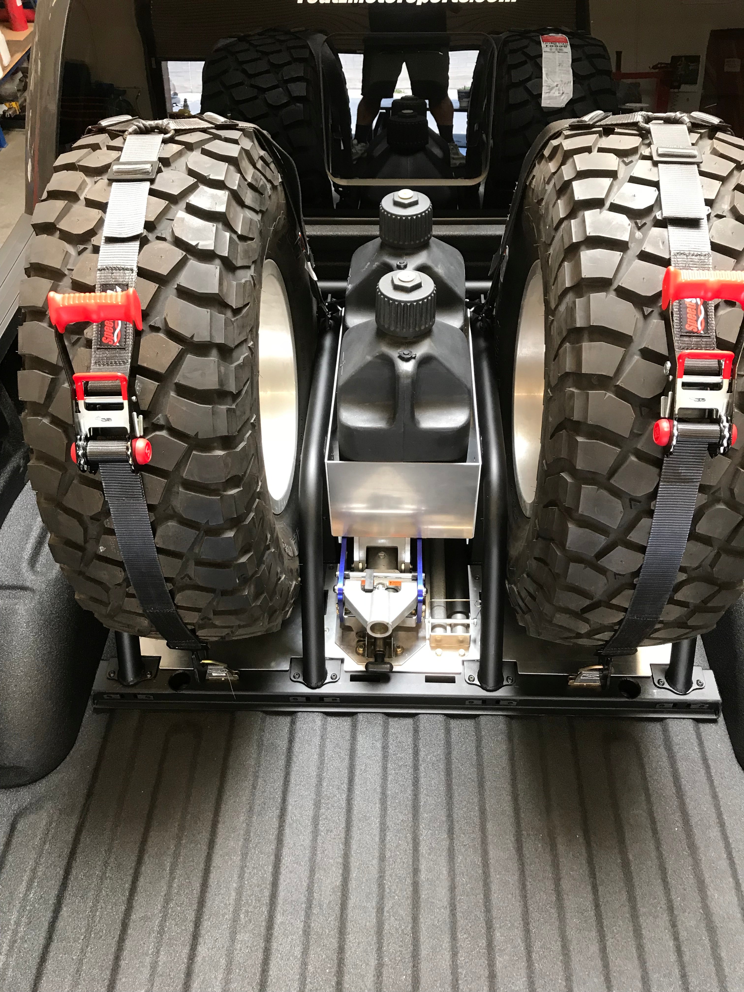 Modular bed organizer for 2017-2024 Ford Raptor featuring a slide-out cargo tray and secure tire storage.