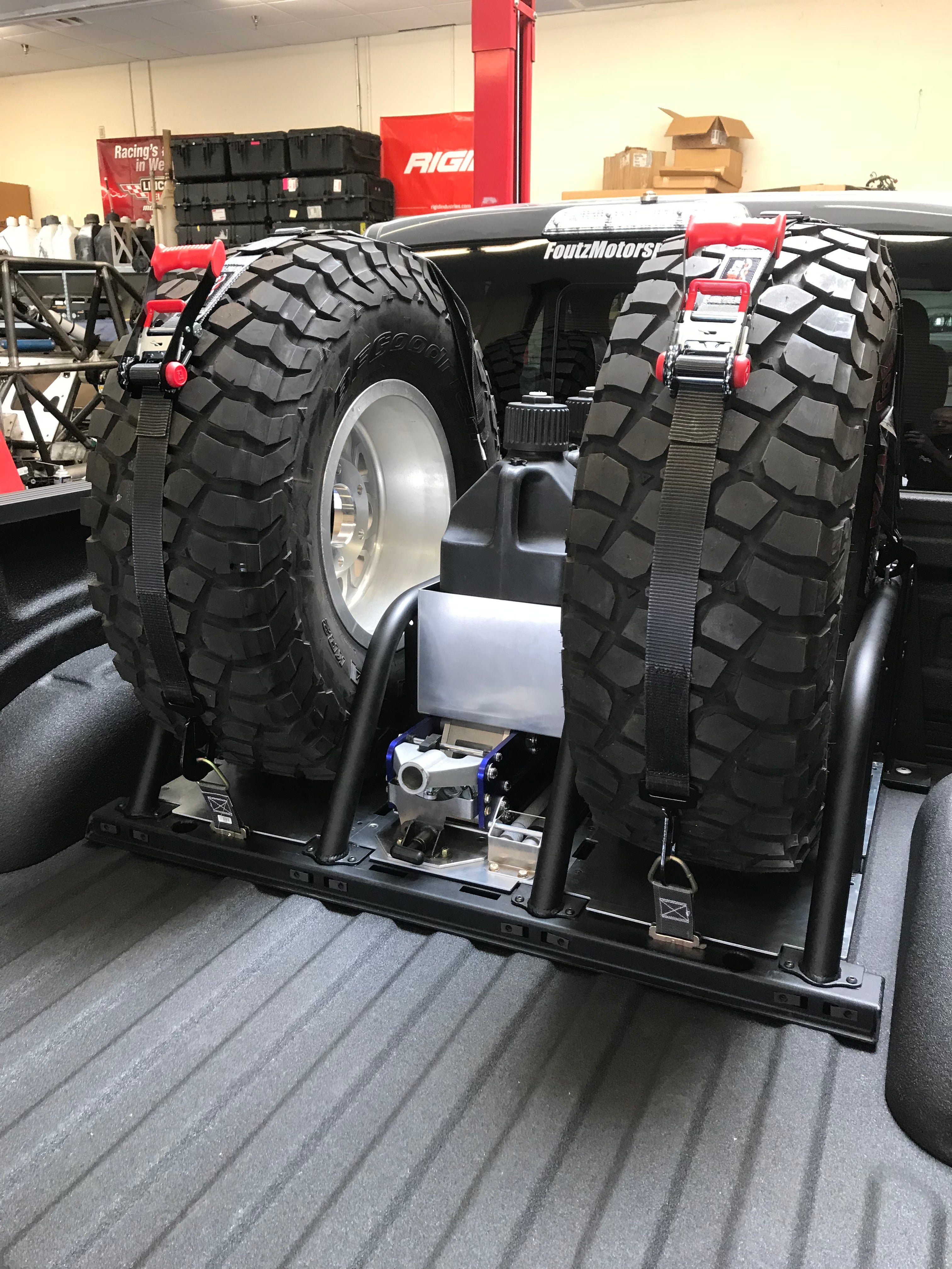 Modular bed organizer for 2017-2024 Ford Raptor featuring a slide-out cargo tray and secured spare tires.