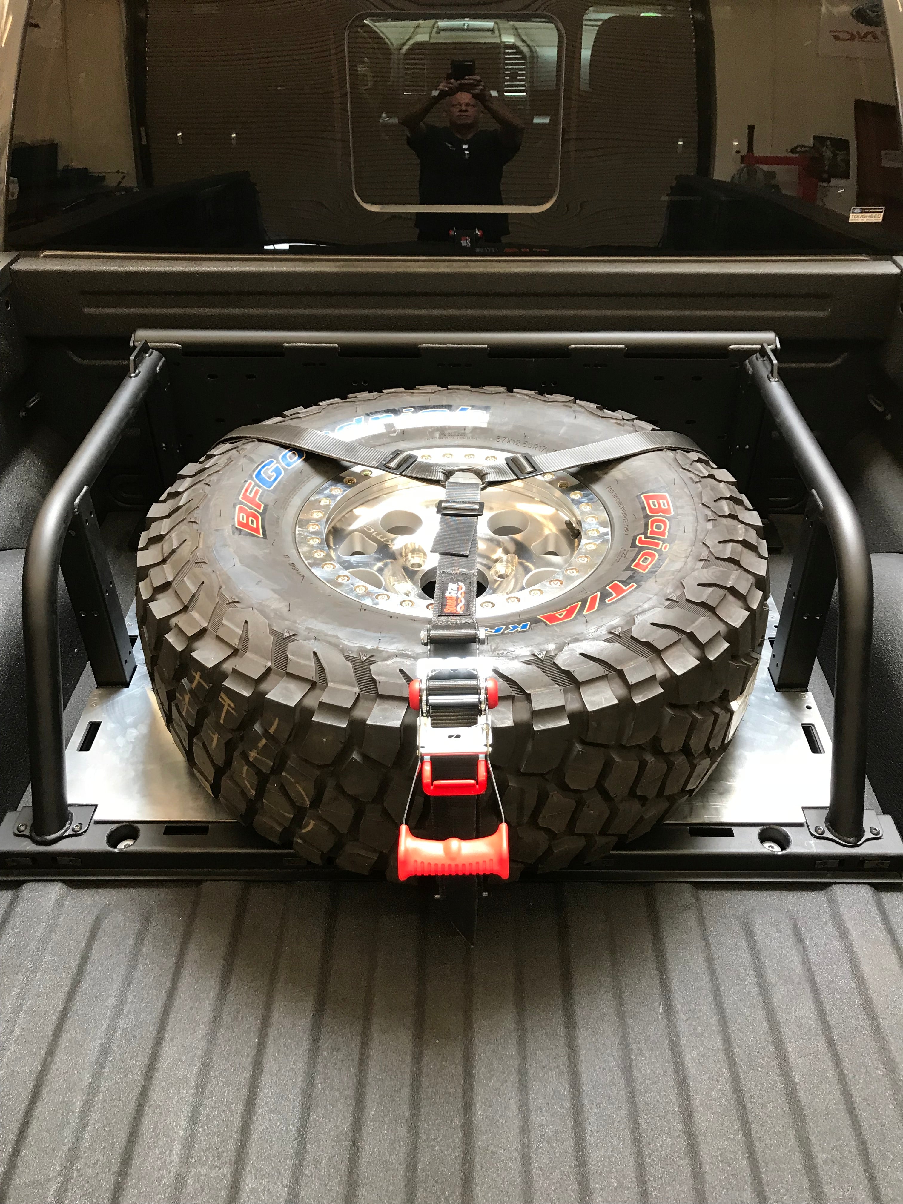 Modular bed organizer for 2017-2024 Ford Raptor and F150, featuring a mounted spare tire and secure strap system.