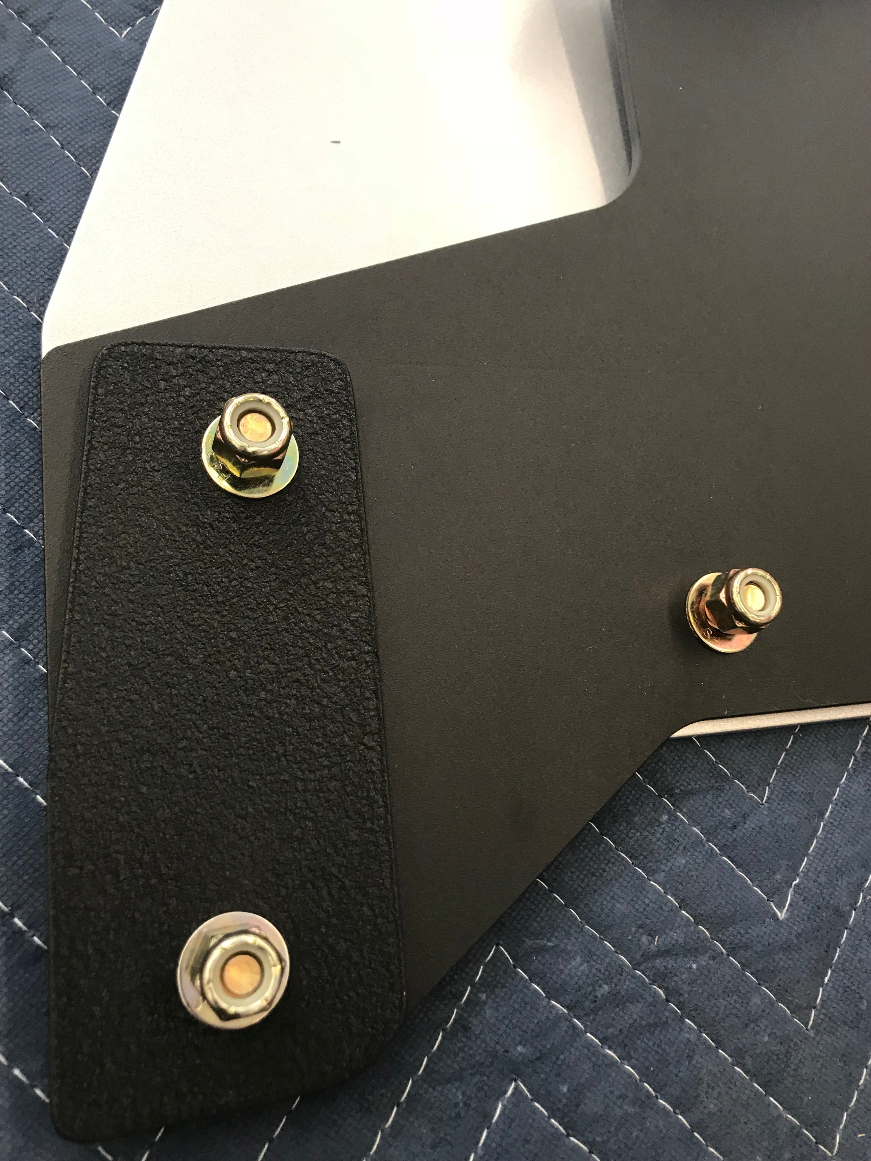 Close-up of a 2019 and newer Ford Ranger skid plate showing mounting hardware and textured surface for durability.