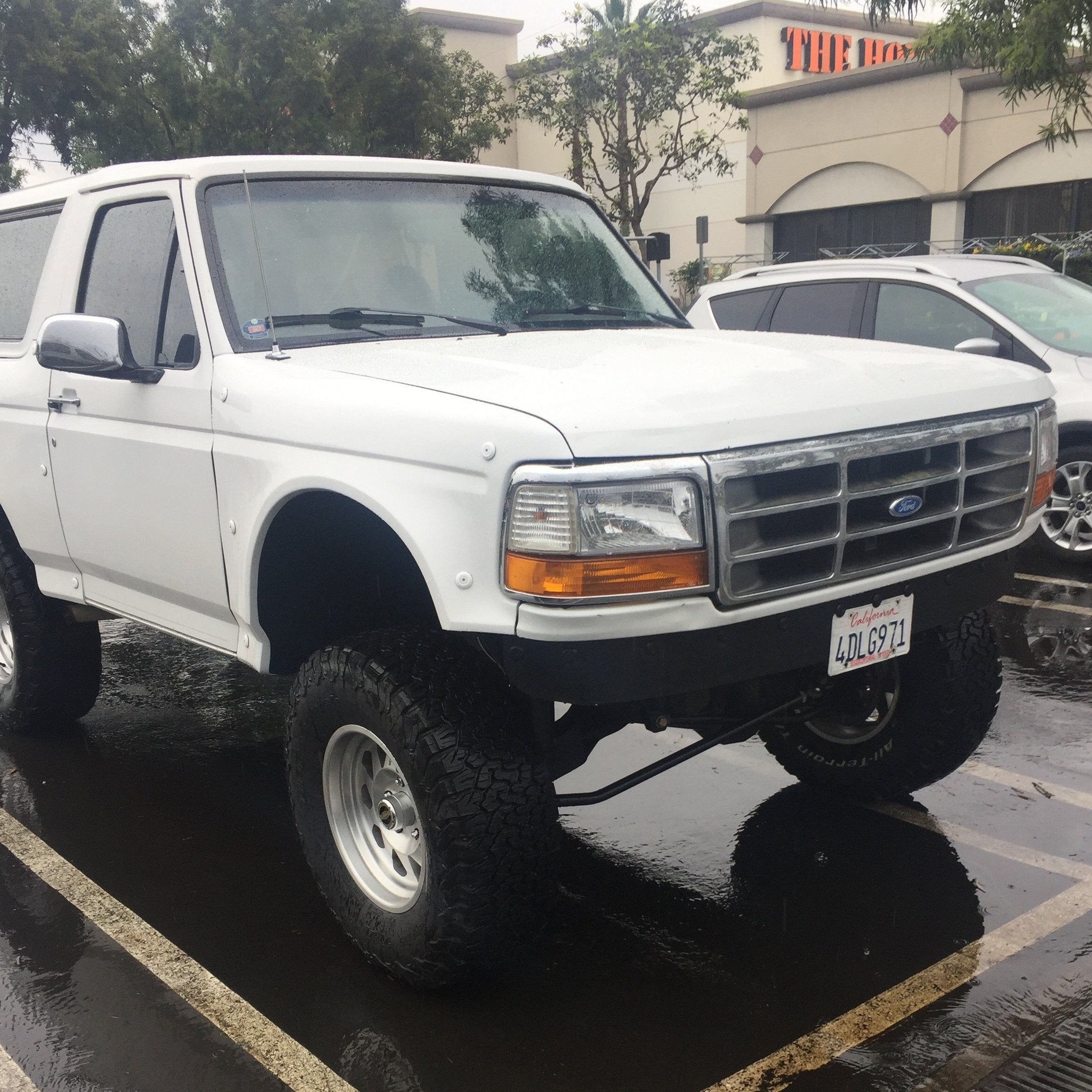1992-1996 Ford Bronco with aftermarket fenders, showcasing an offroad-ready stance and rugged tires.