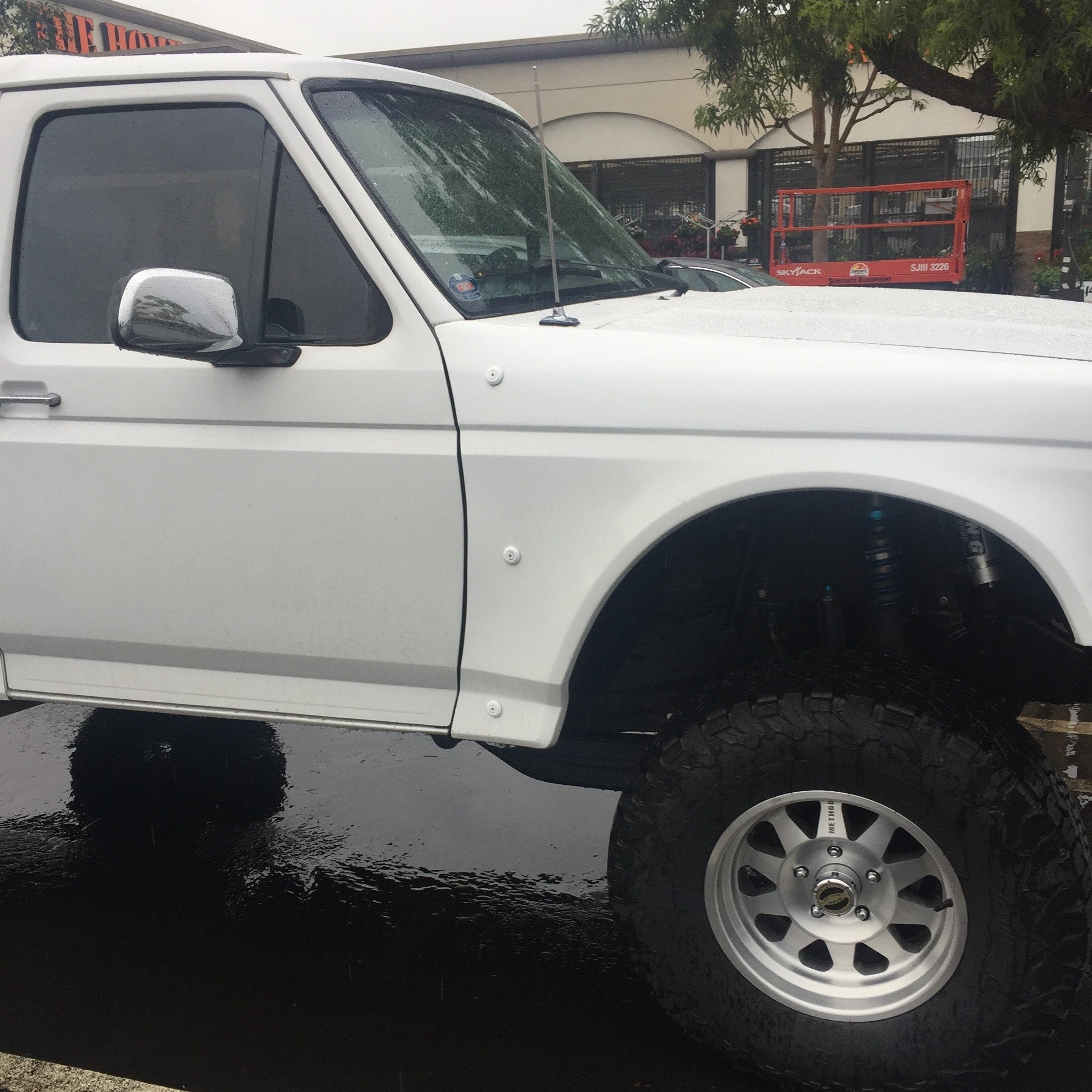 1992-1996 Ford Bronco fenders installed on a lifted white truck, showcasing offroad-ready design and durability.