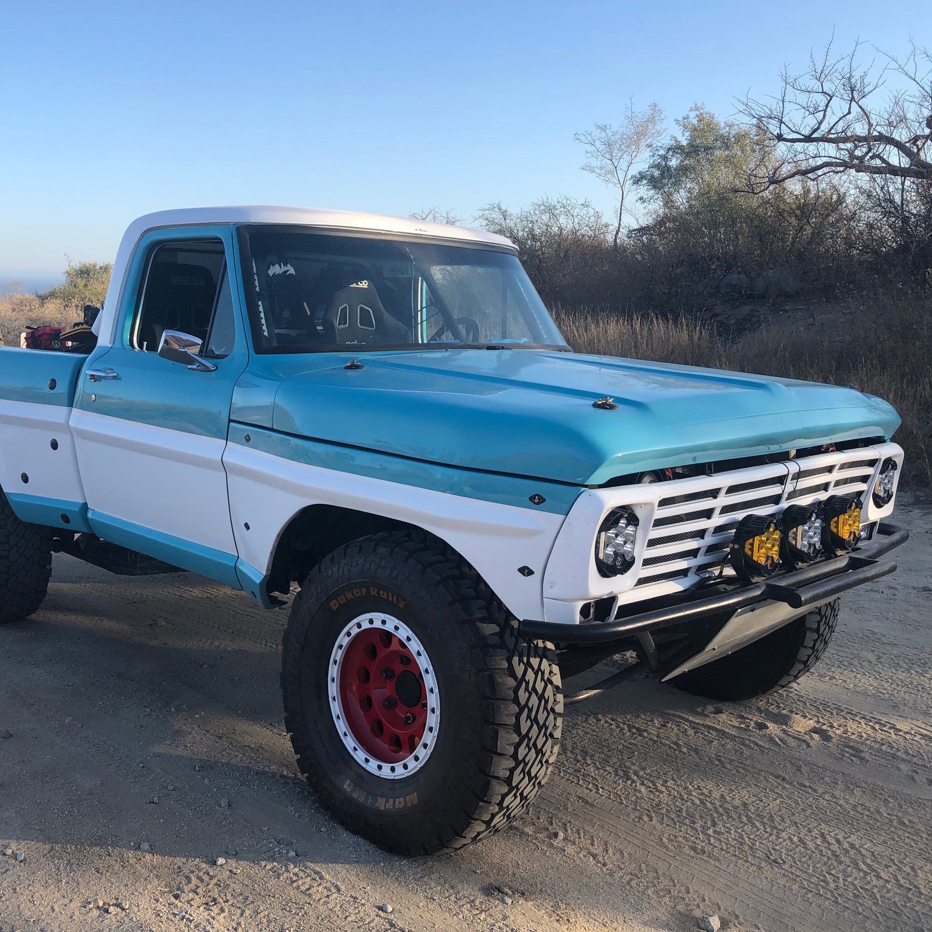1967-1972 Ford F-100 frontend showcasing a classic truck design with a two-tone blue and white paint job.