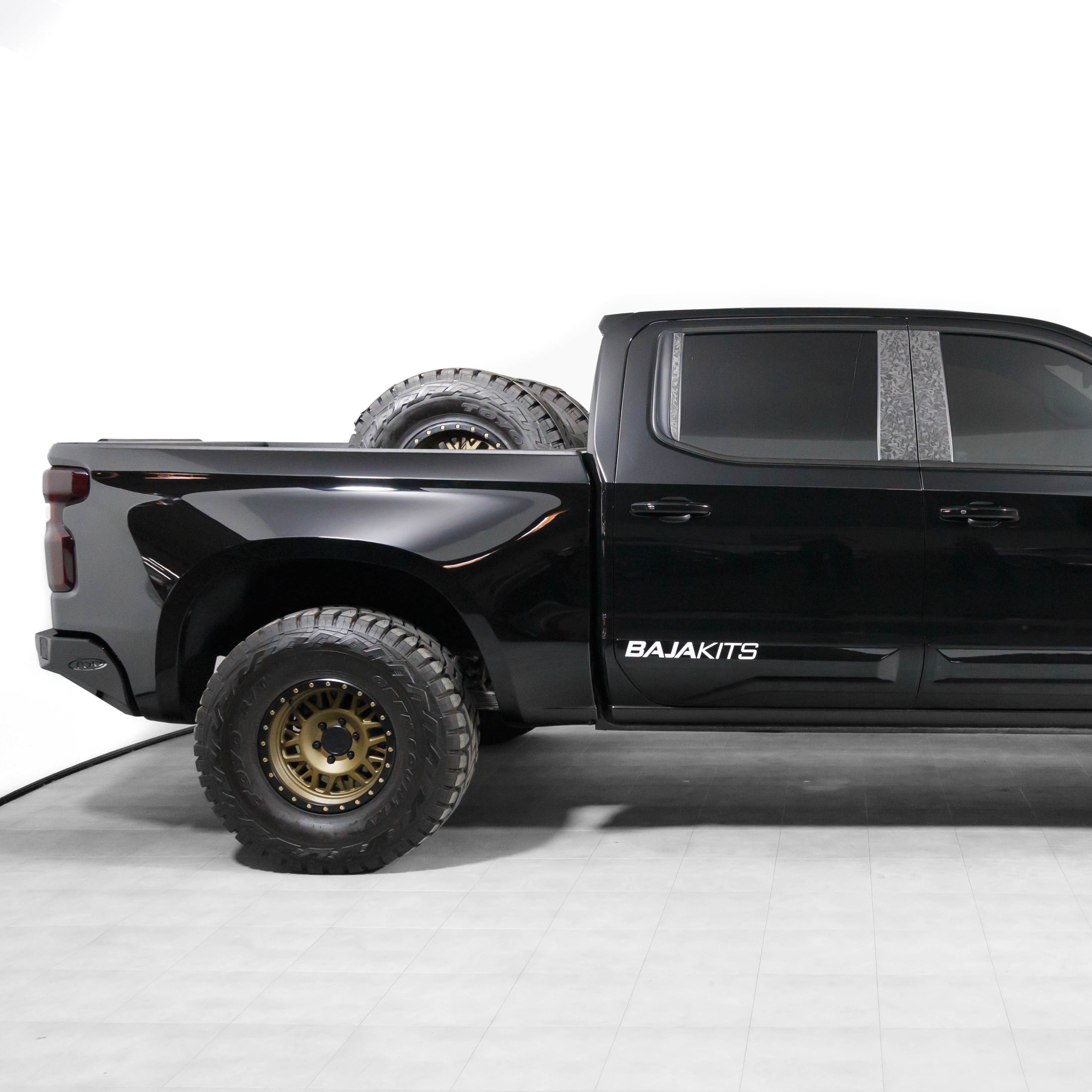2019-2025 Chevrolet Silverado with custom bedsides and off-road tires, showcasing a sleek black finish and rugged design.