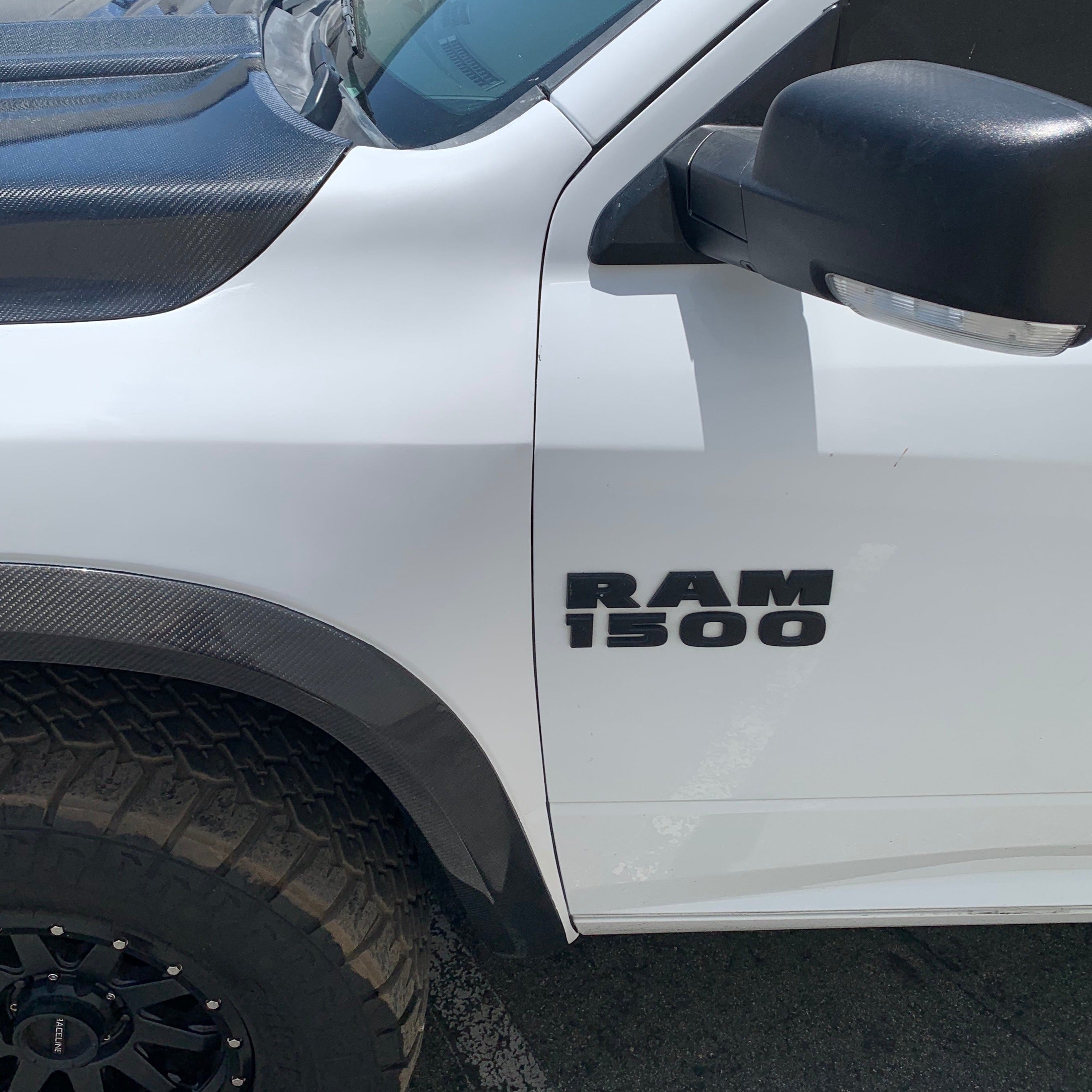 2009-2018 Dodge Ram TRX Kit showcasing the truck's RAM 1500 badge and rugged tire design. Ideal for offroad enthusiasts.