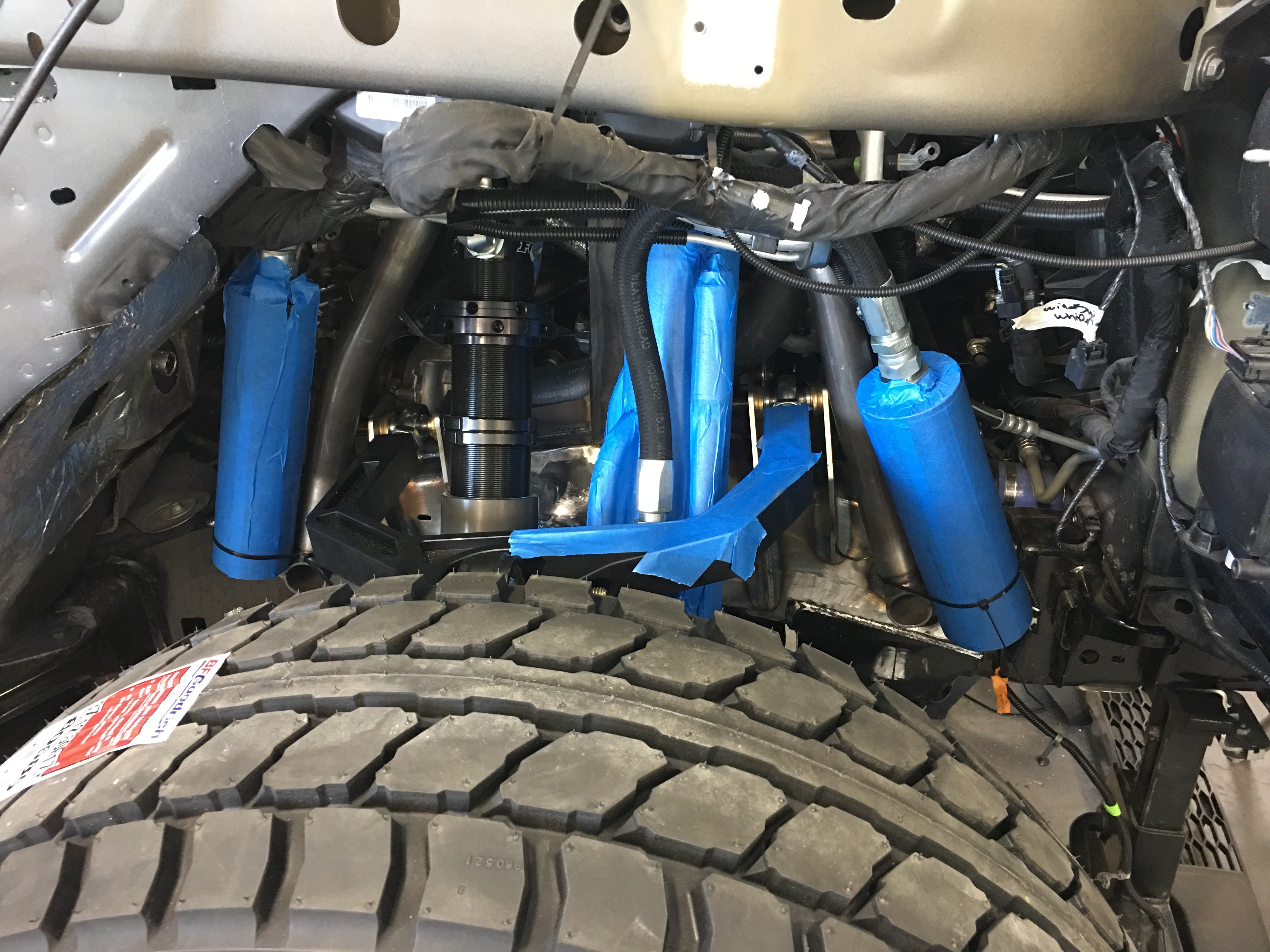Long travel front suspension kit for 2017 and newer Raptor, showcasing components and installation details.