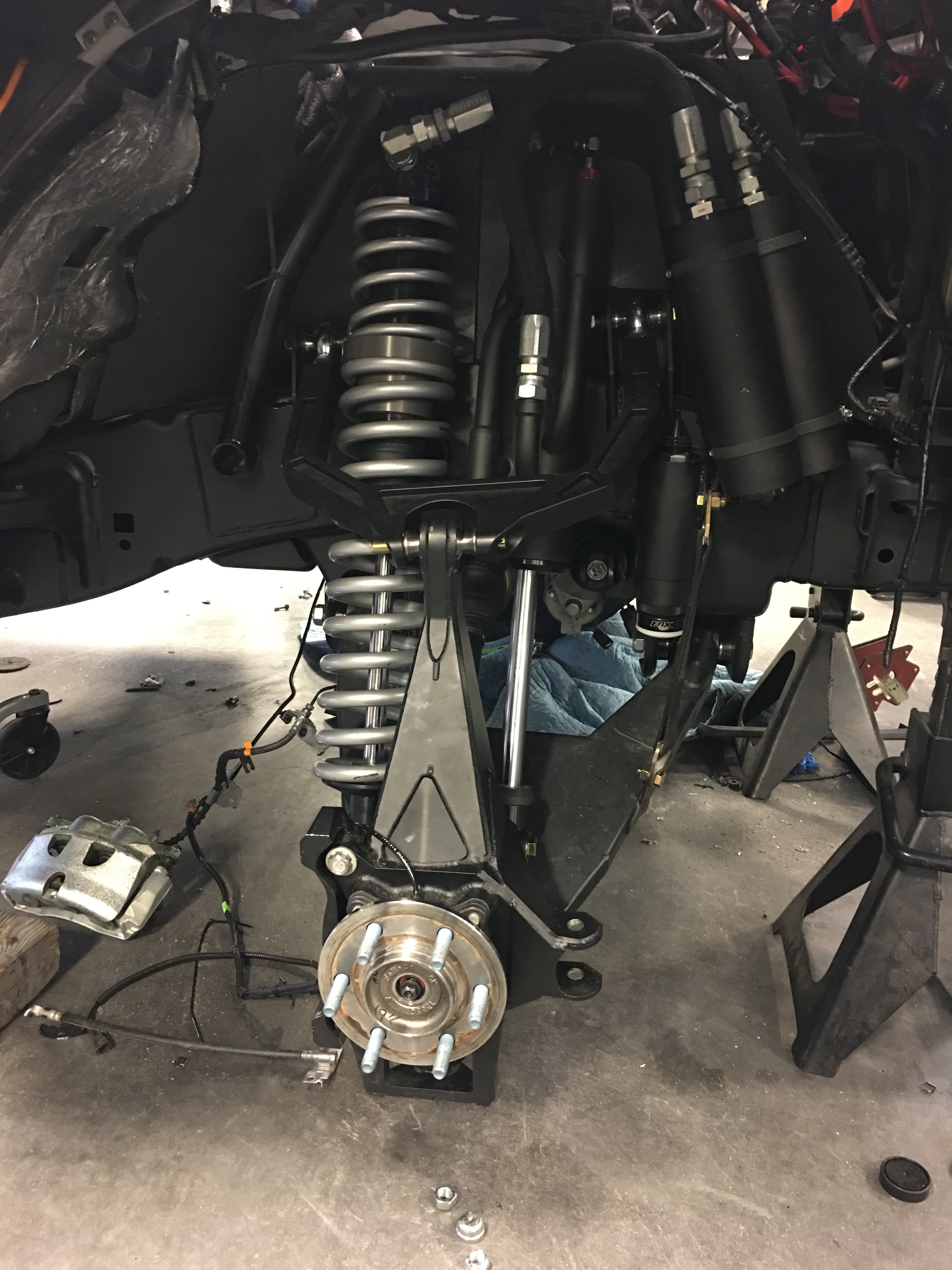 2017 Up Raptor Long Travel Front Suspension Kit showcasing detailed components and installation setup for enhanced offroad performance.