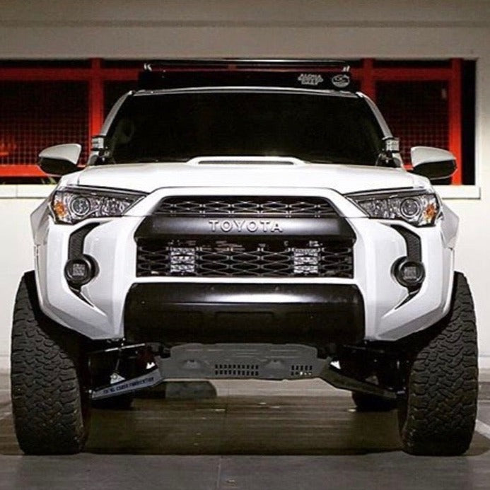 Front view of a modified 2010-2024 Toyota 4-Runner showcasing aftermarket fenders and off-road tires.