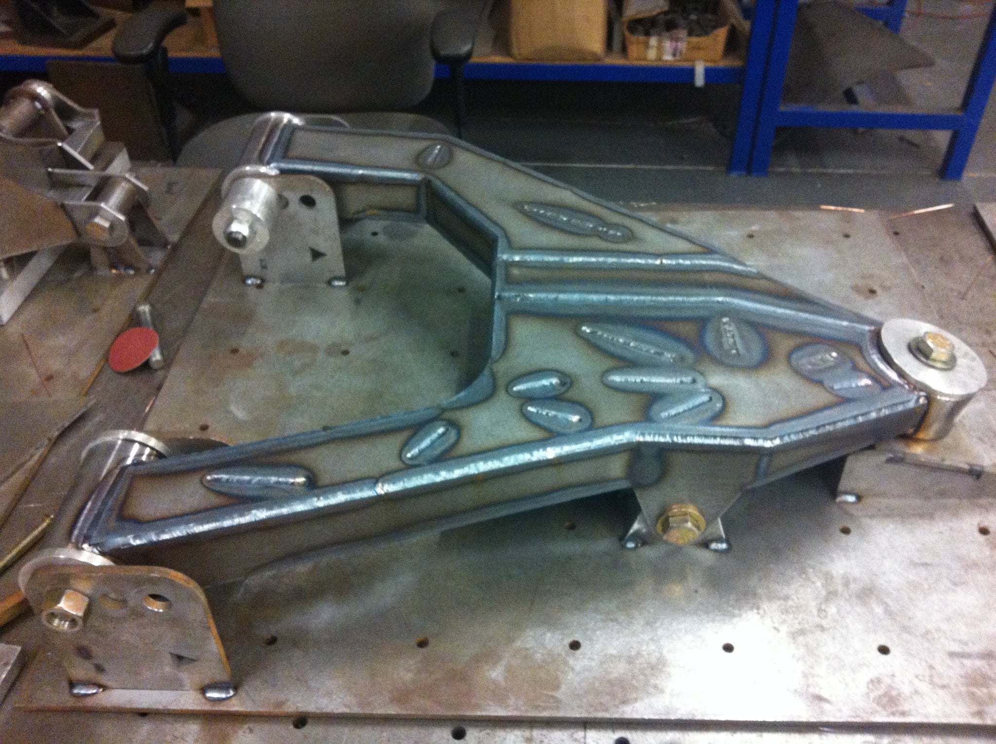 Long travel front suspension kit for 2010-2014 Raptor, showcasing robust metal construction and intricate welds.
