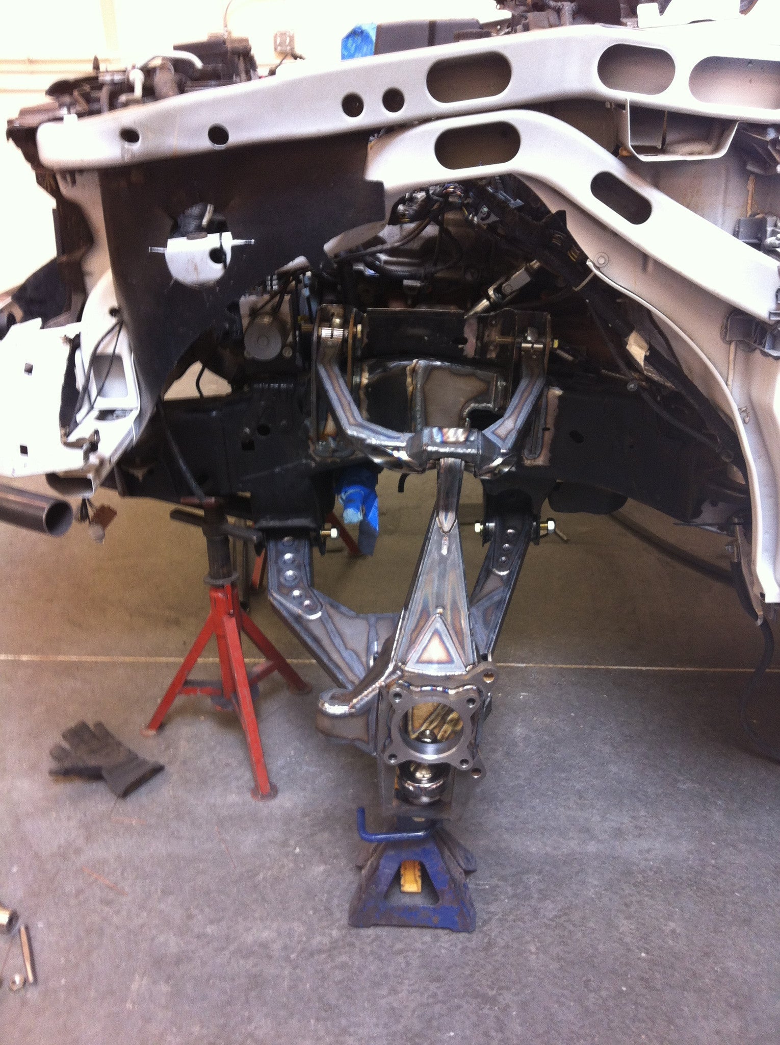 Long travel front suspension kit installed on a 2010-2014 Raptor chassis, showcasing enhanced off-road performance components.