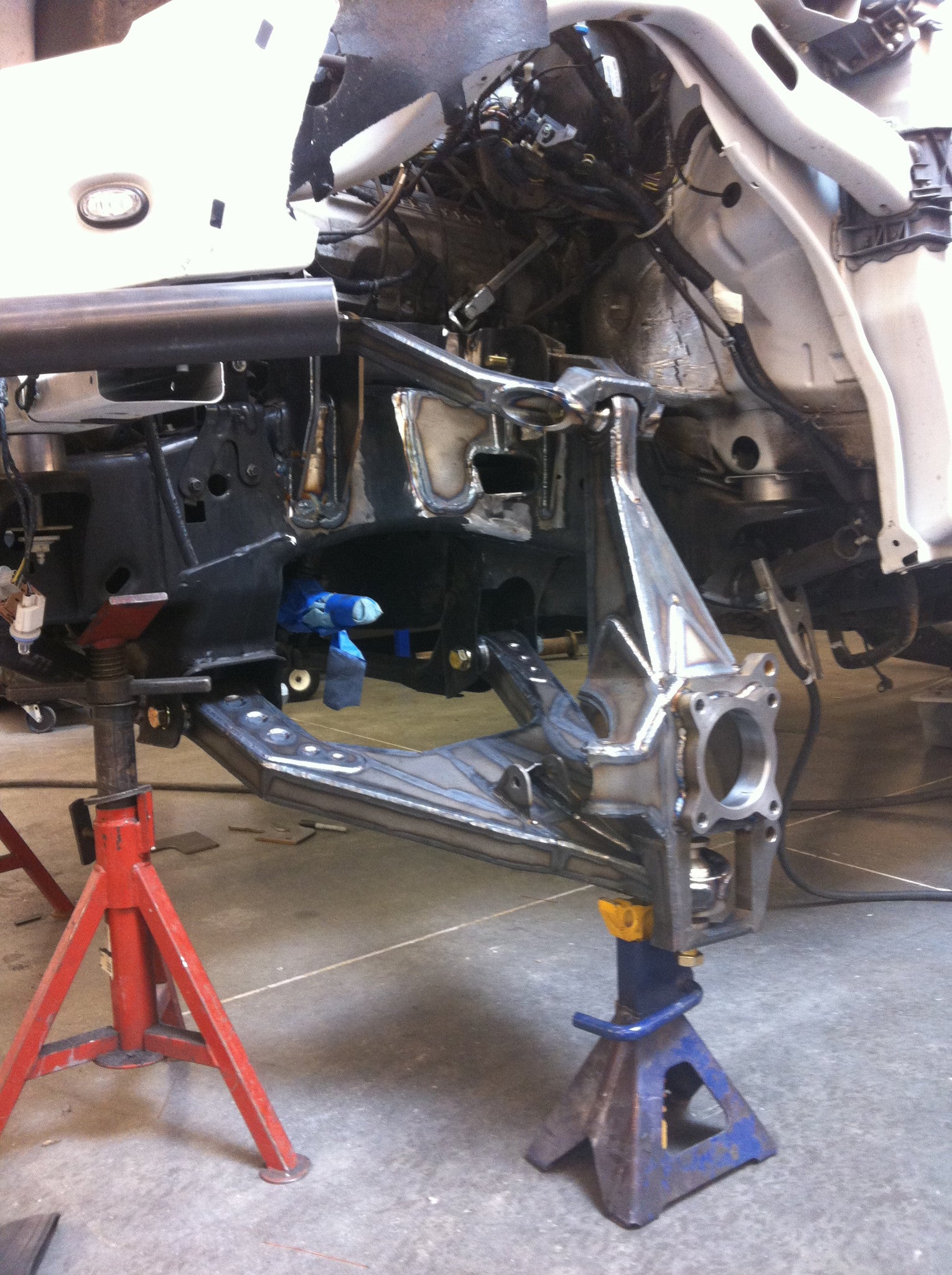 Long travel front suspension kit for 2010-2014 Raptor, showcasing installation with detailed components and supports.