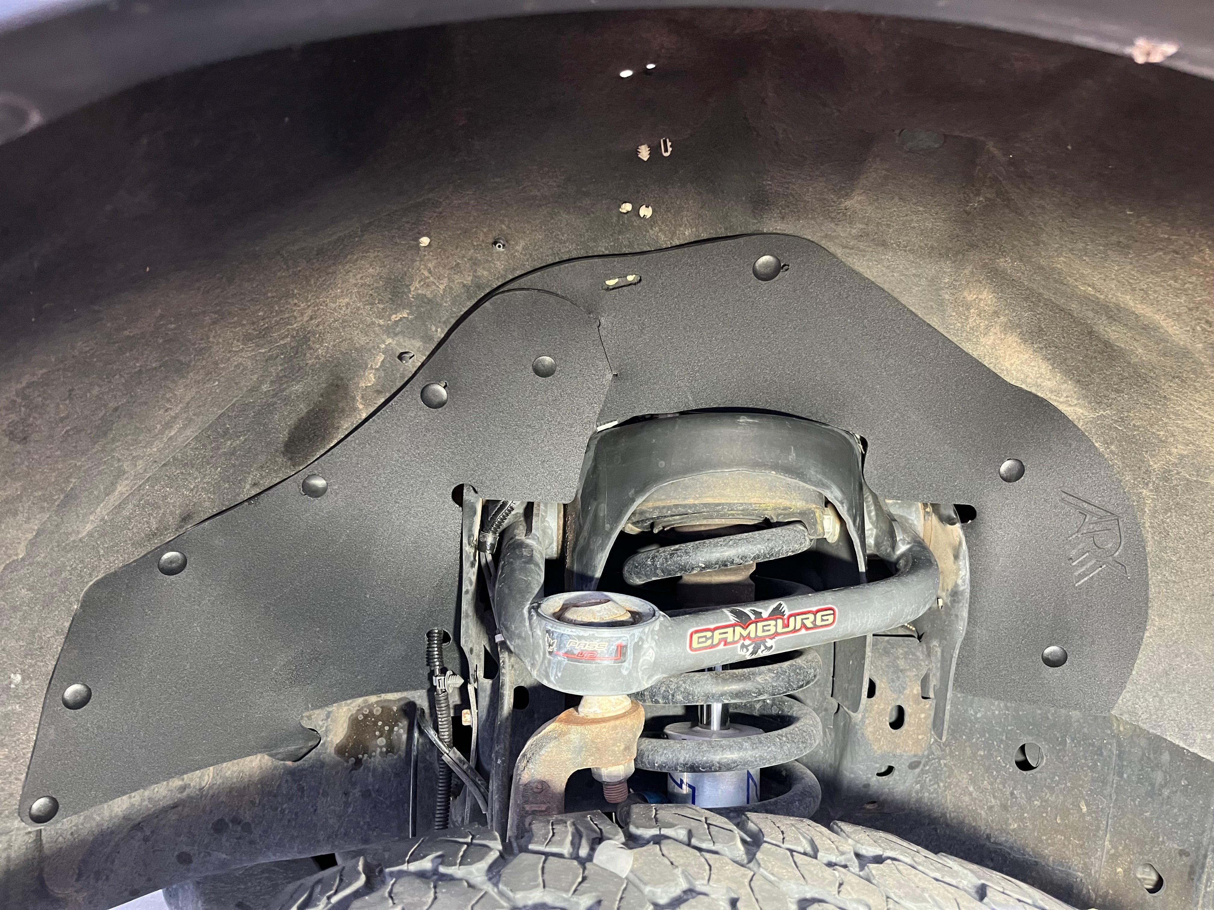 2010-2014 Ford F150 EcoBoost splash guards installed, protecting the undercarriage from dirt and debris.