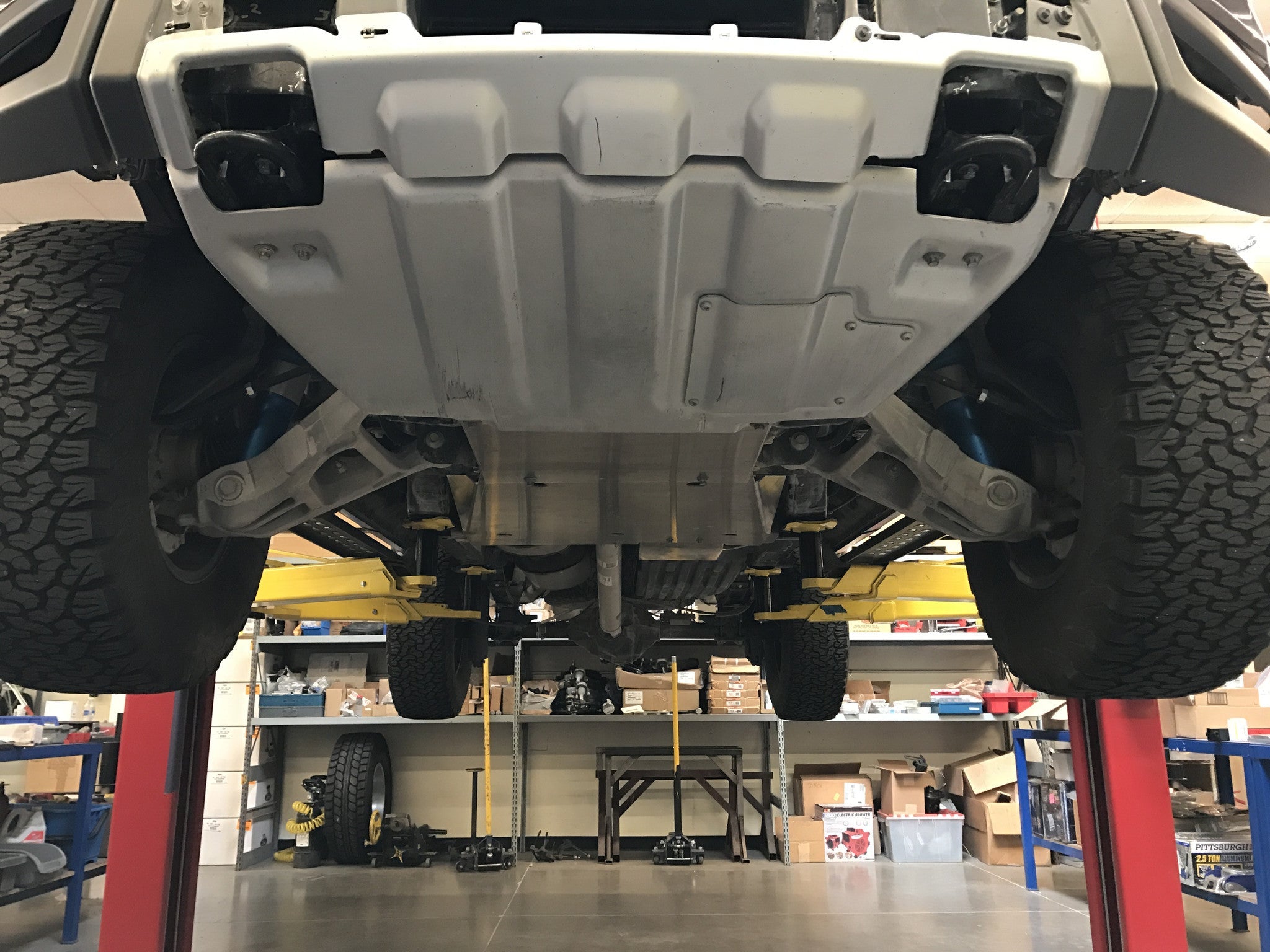 Skid plate kit installed on a 2017-2024 Ford Raptor, showcasing undercarriage protection and rugged design.