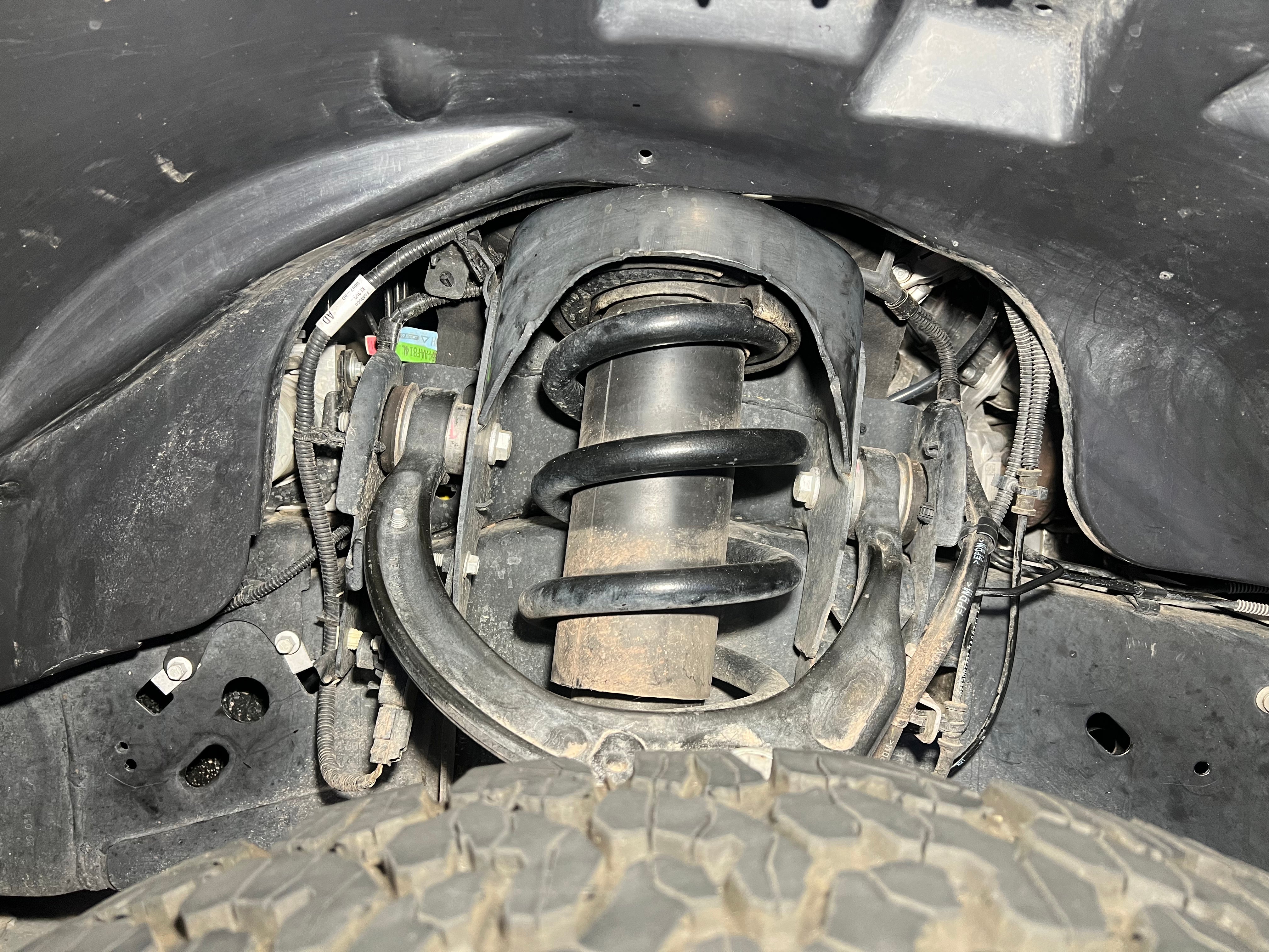 2017-2020 Ford Raptor splash guards showcasing the suspension system and tire clearance for enhanced offroad protection.