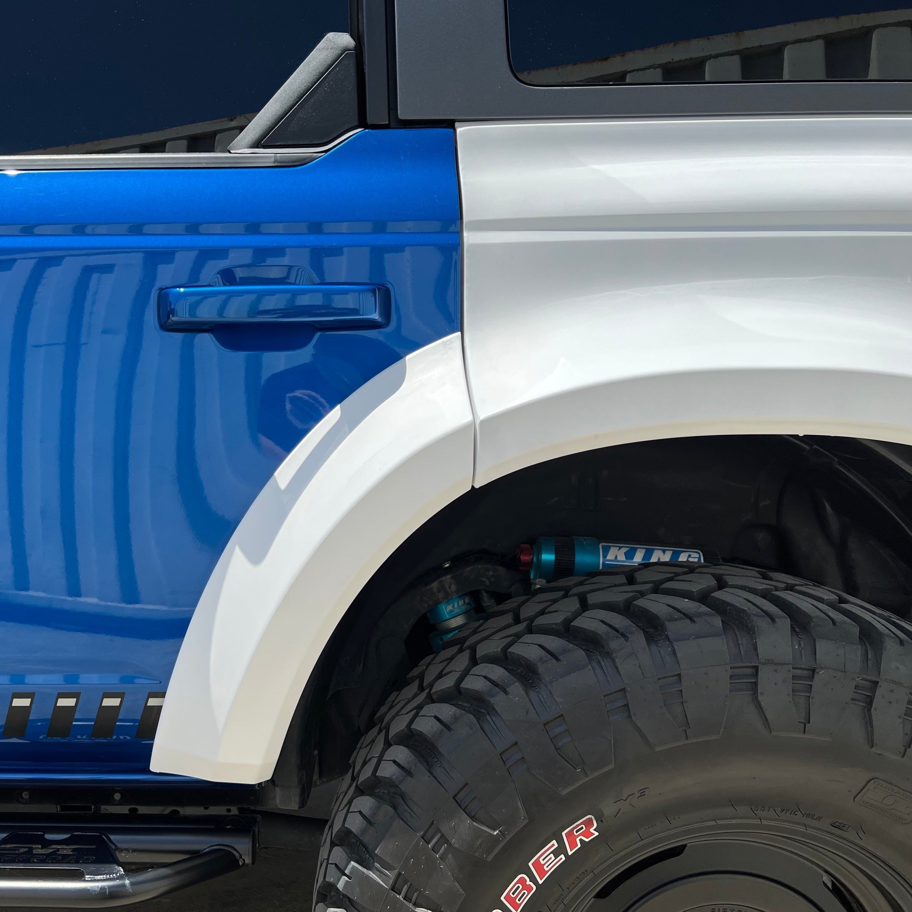 2021-2025 Ford Bronco 4-Door Rear Quarter Kit showcasing a blue and white color scheme with offroad tire and suspension details.