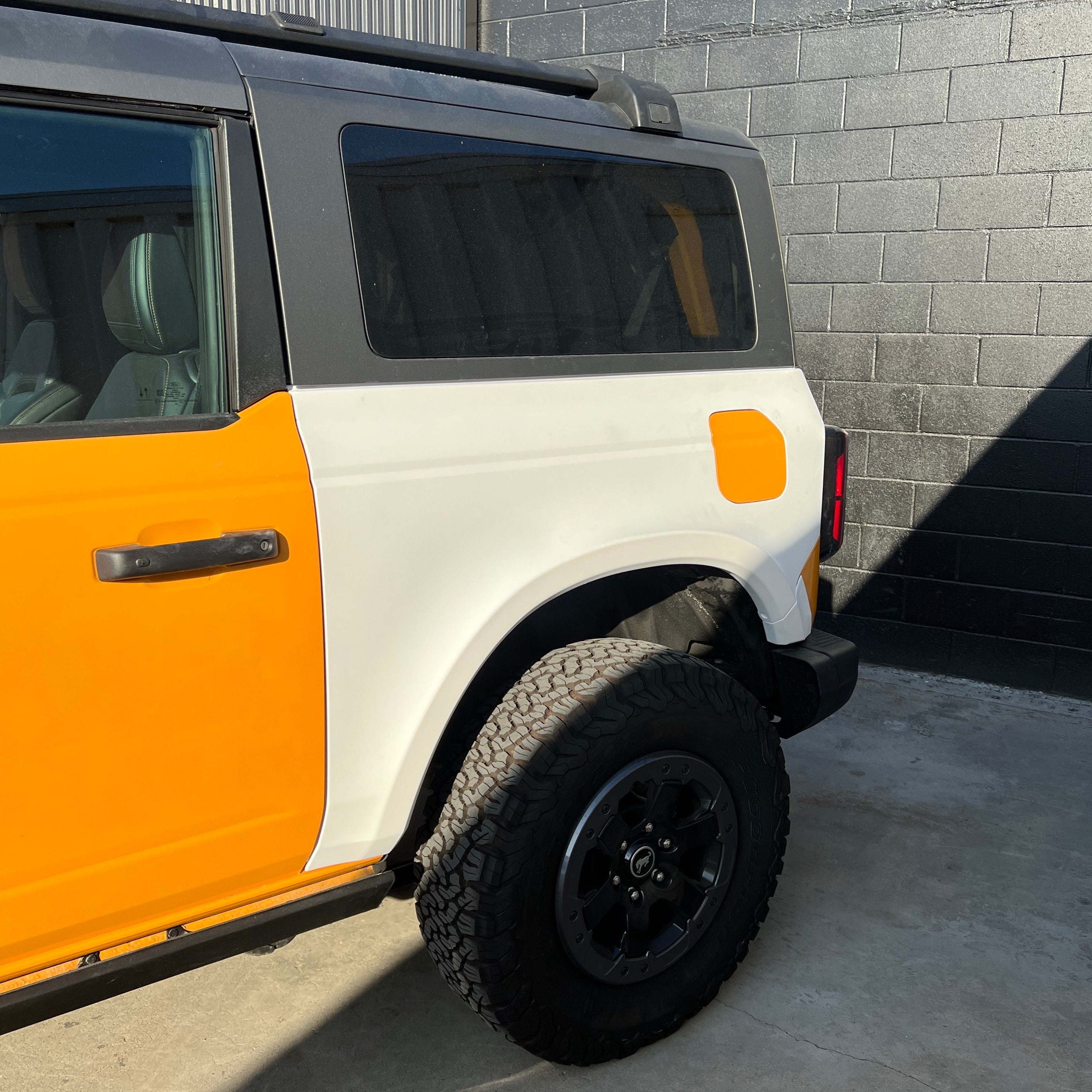 2021-2025 Ford Bronco 2-Door Rear Quarter Kit showcasing a two-tone design with orange and white panels.