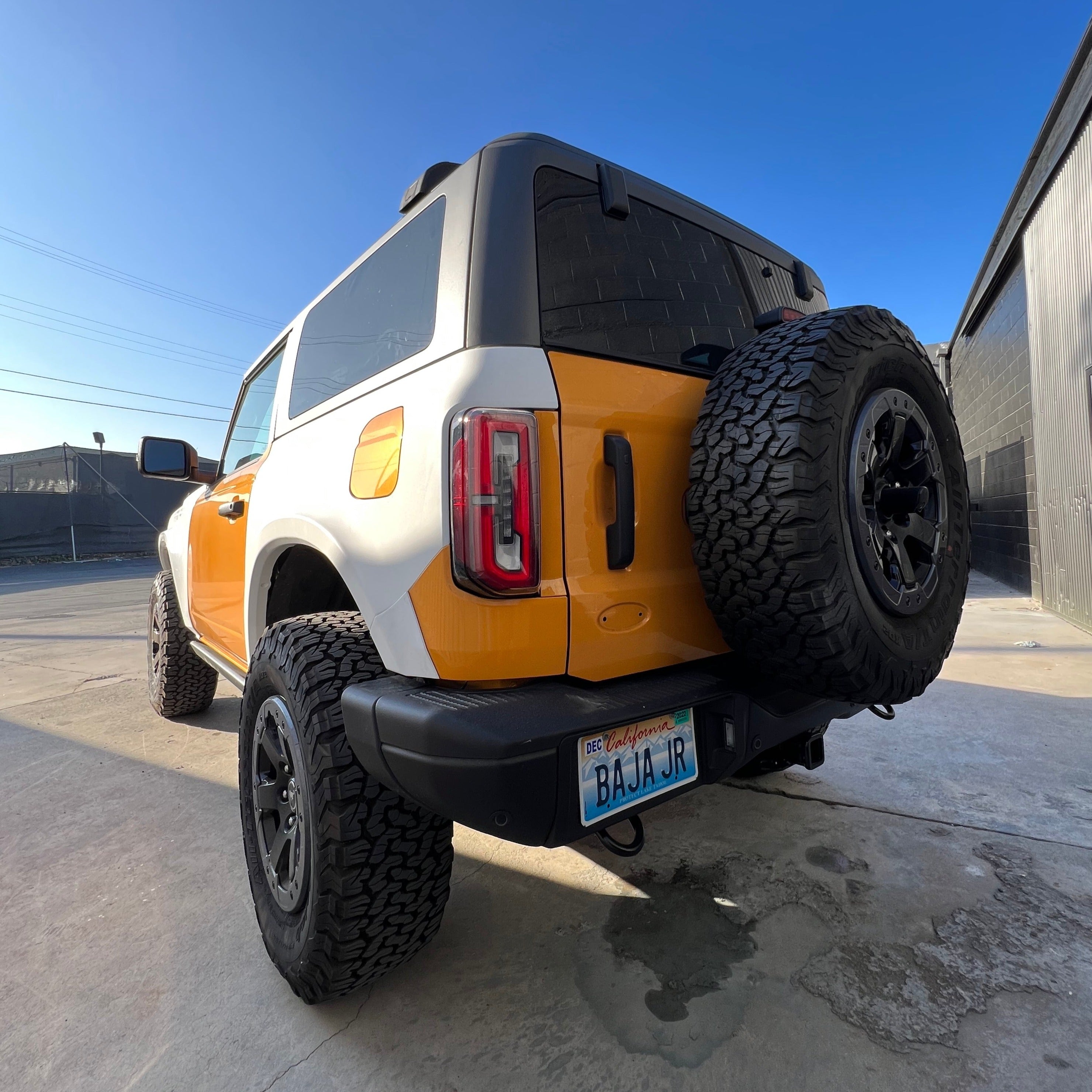 2021-2025 Ford Bronco 2-Door Rear Quarter Kit installed on a customized Bronco with offroad tires and a vibrant color scheme.