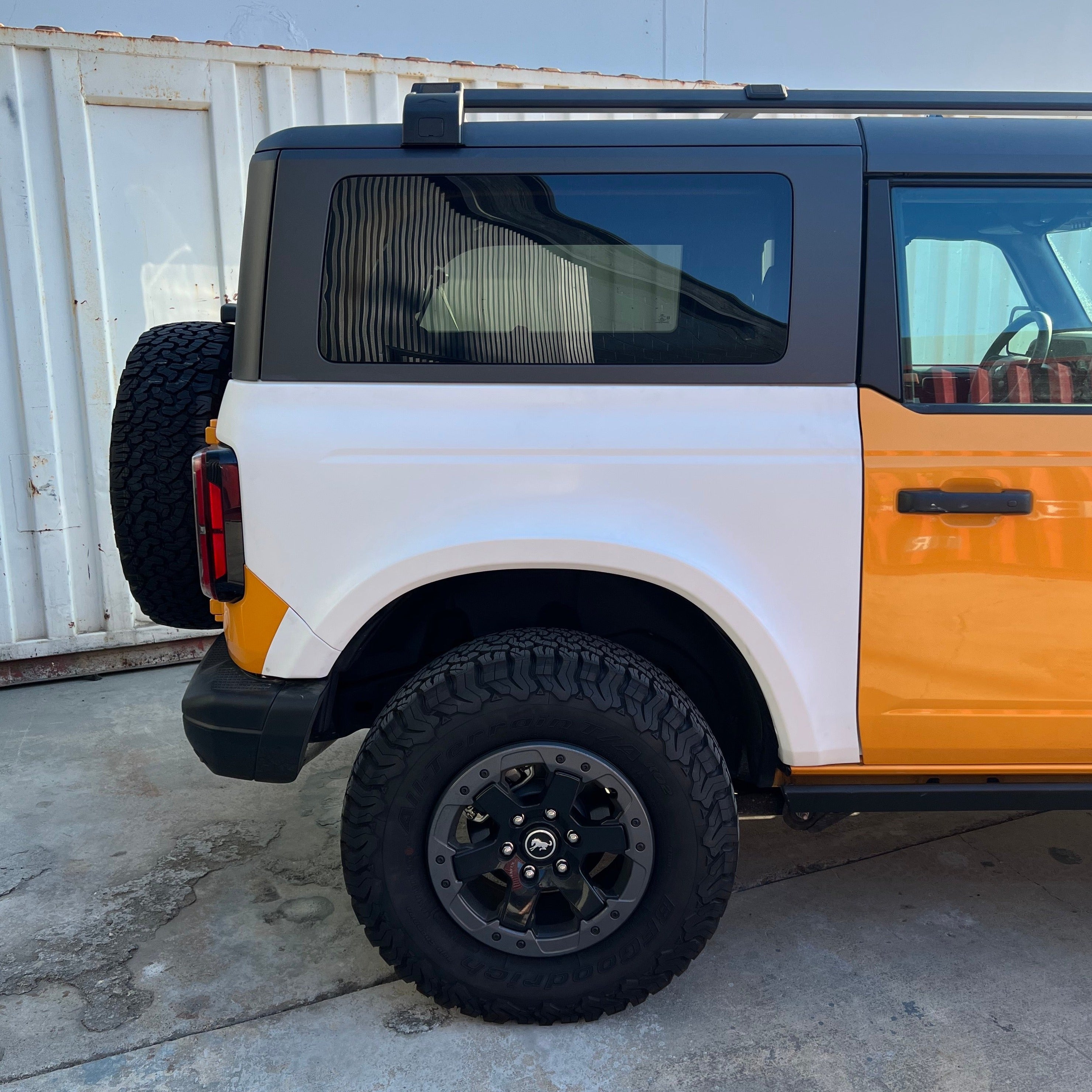 2021-2025 Ford Bronco 2-Door Rear Quarter Kit showcasing a vibrant orange and white design with rugged tires.