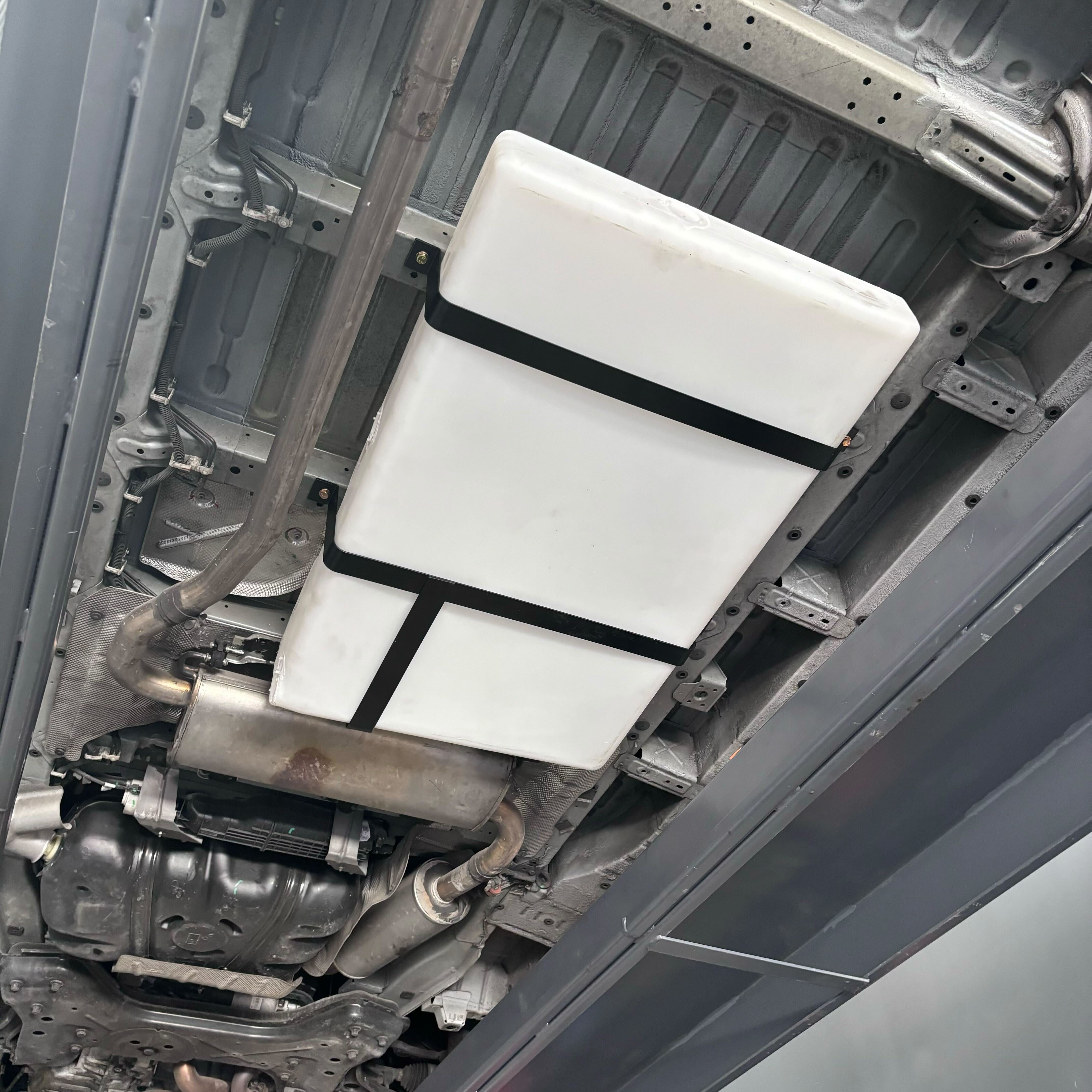 36-gallon undercarriage fresh/grey water tank installed under a vehicle, compatible with Ford and Dodge/Ram models.