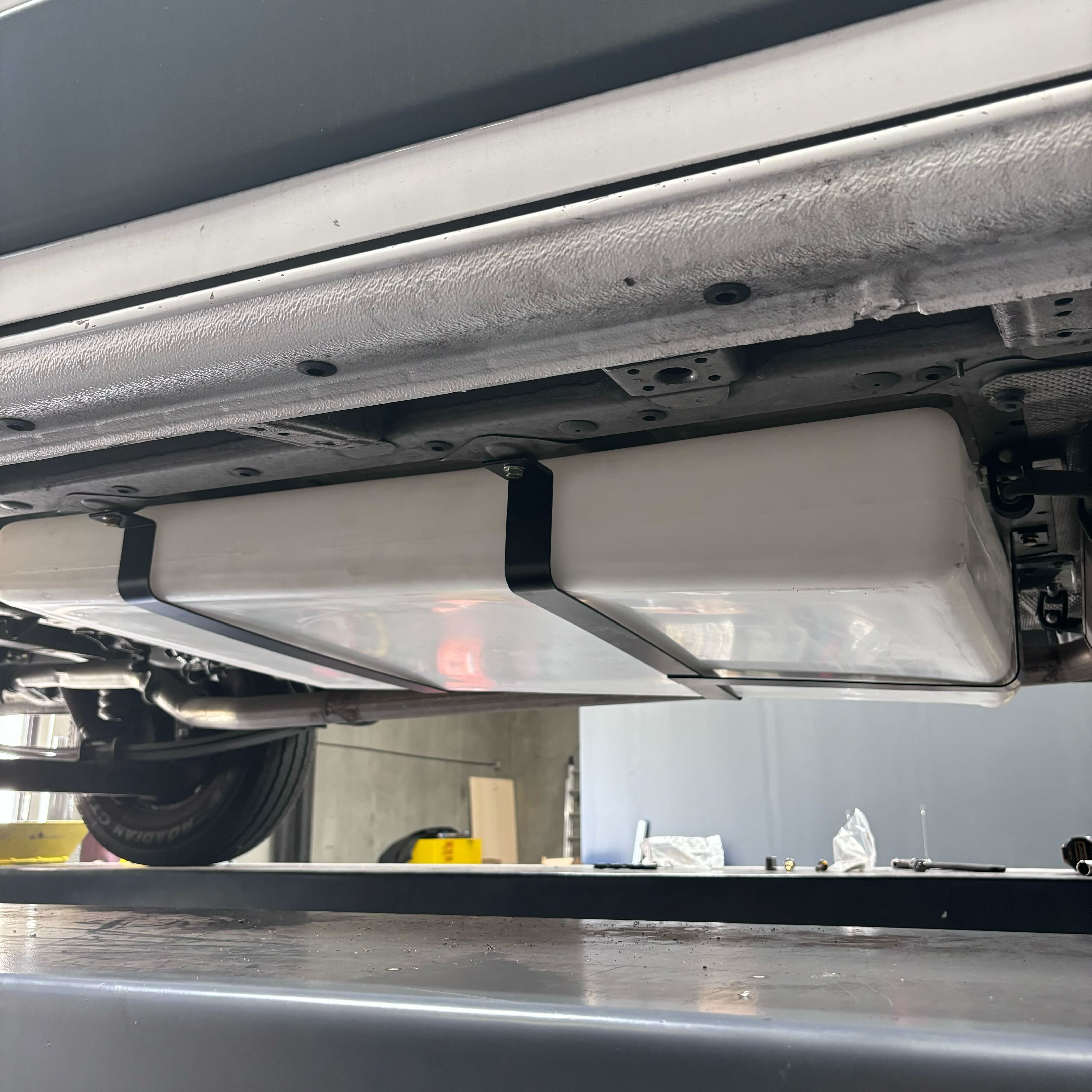36-gallon undercarriage fresh/grey water tank installed on a Ford or Dodge Ram Promaster, showcasing durable design and secure mounting.