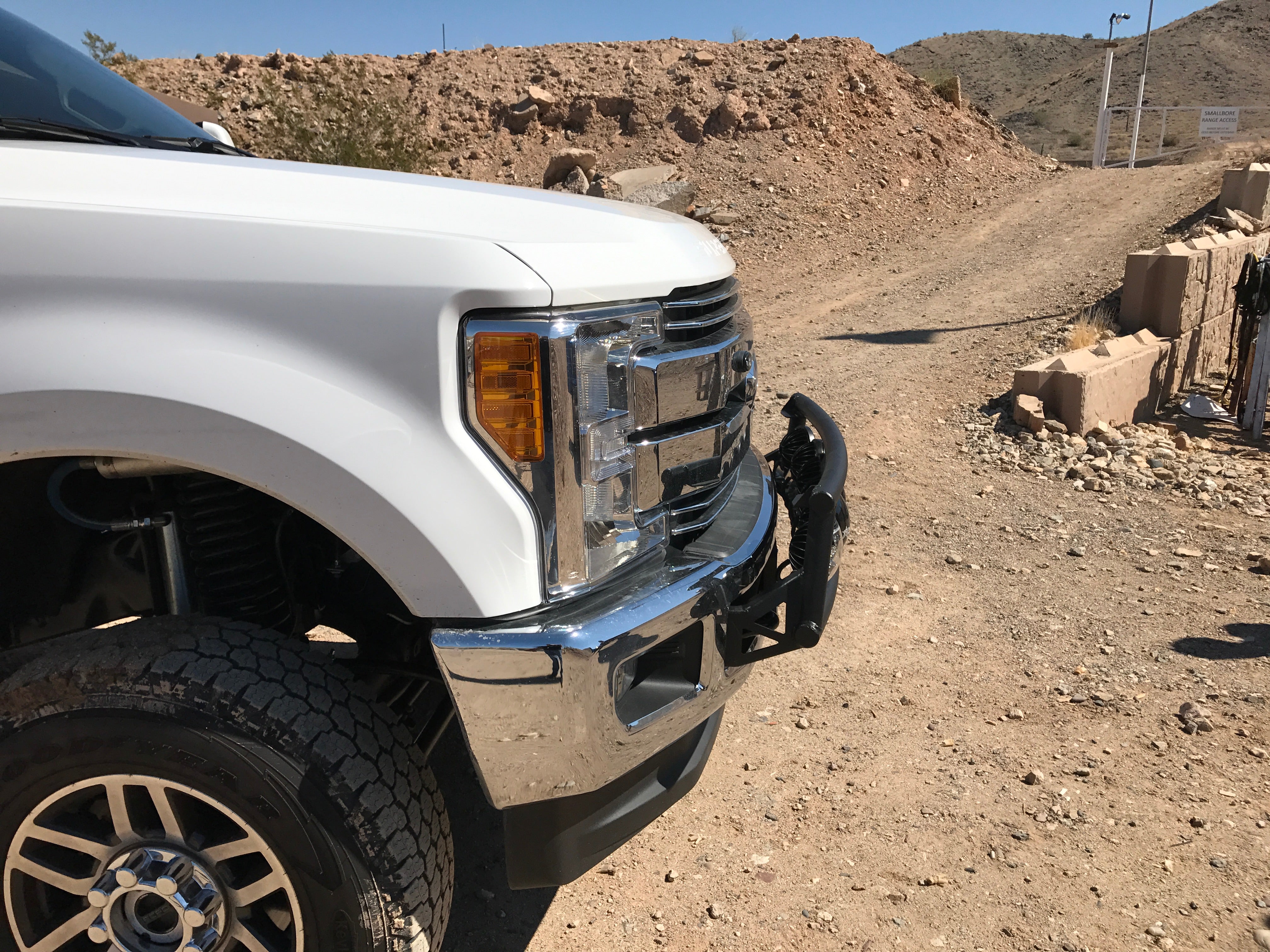 Light mount kit for 2017-2020 Ford Super Duty, designed for stock front bumper, showcased on a rugged terrain.
